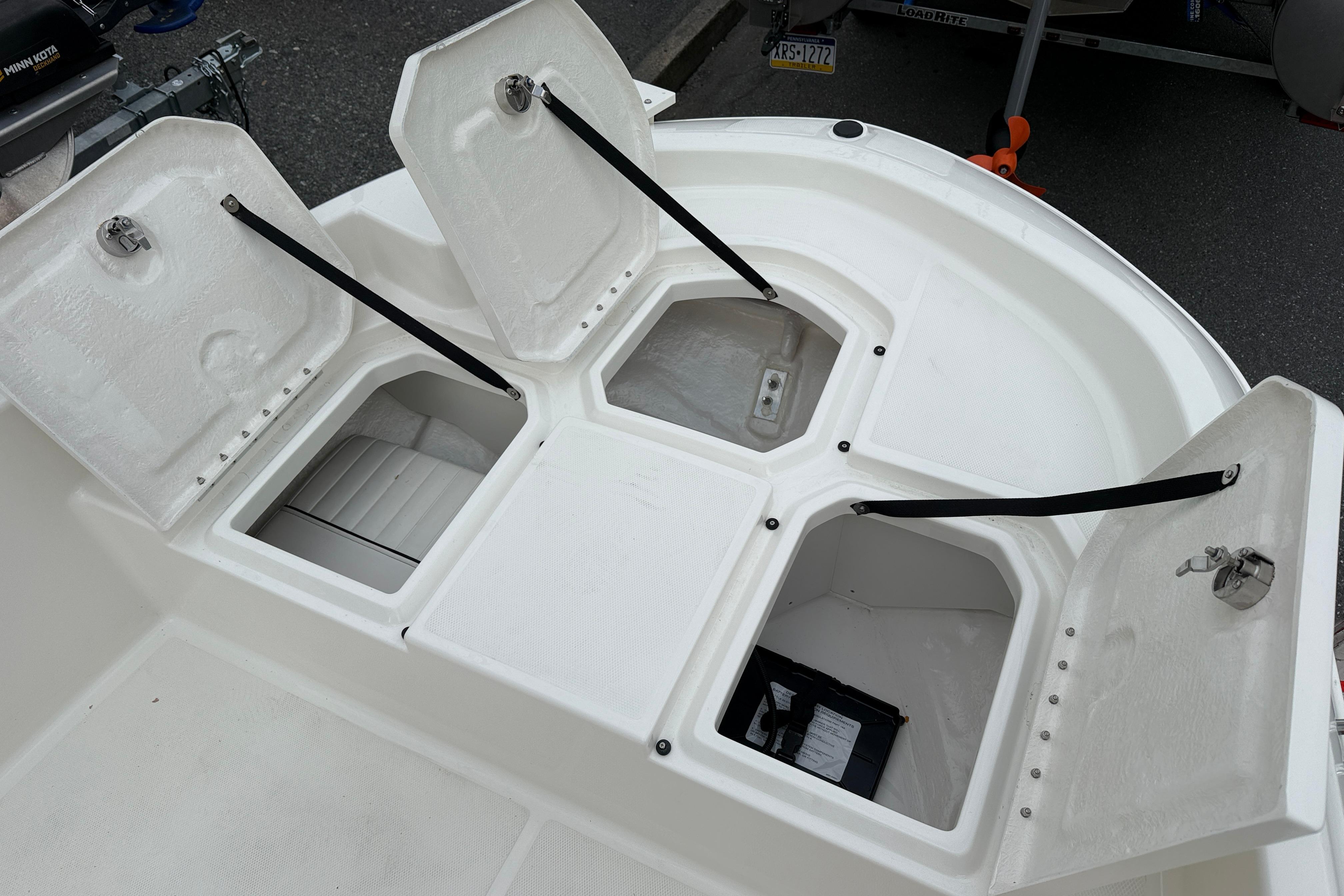 2026 Bayliner Trophy T18 boat storage compartments open, showcasing spacious interior design.