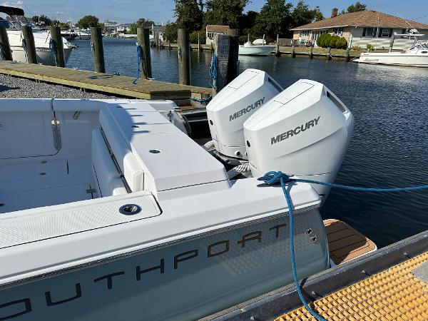 2025 Southport 33 FE boat with dual Mercury engines docked at a marina.