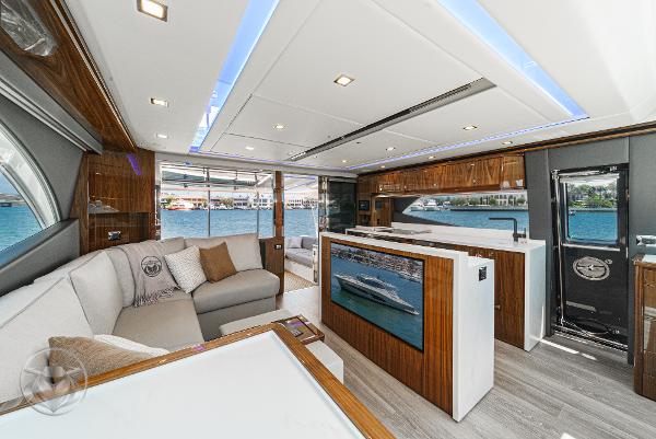 Luxurious interior of 2025 Riviera 645 SUV yacht with modern furnishings and ocean view.