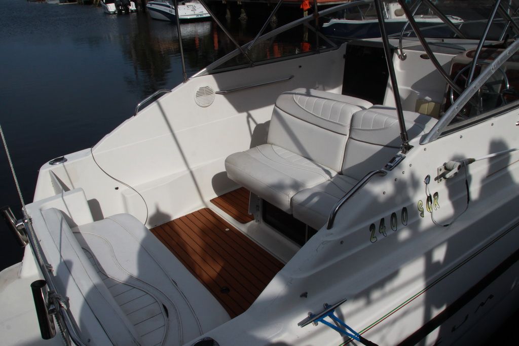 Interior of a 1999 Maxum 2400 Mercruiser boat with white seating.