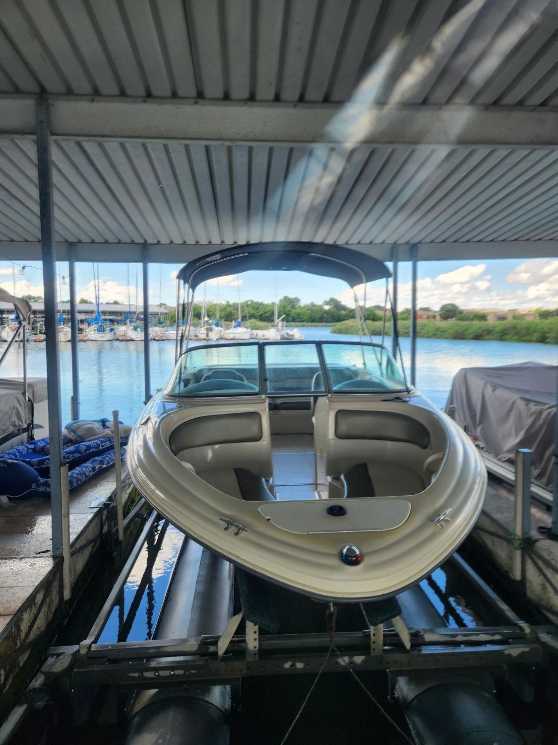 2004 Sea Ray 185 boat docked under cover.