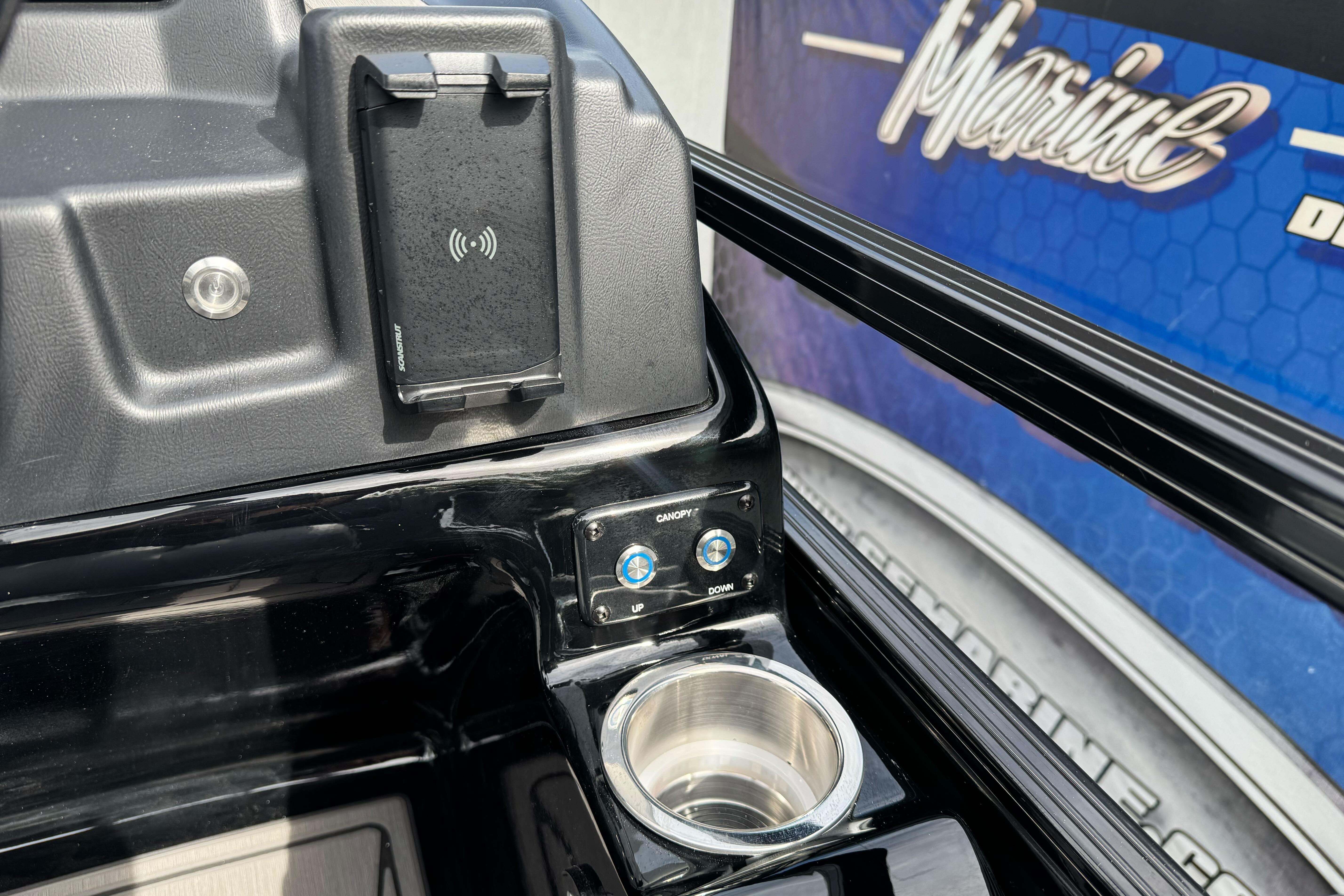 Dashboard of 2026 Regency 250 DL boat with wireless charger and cup holder.