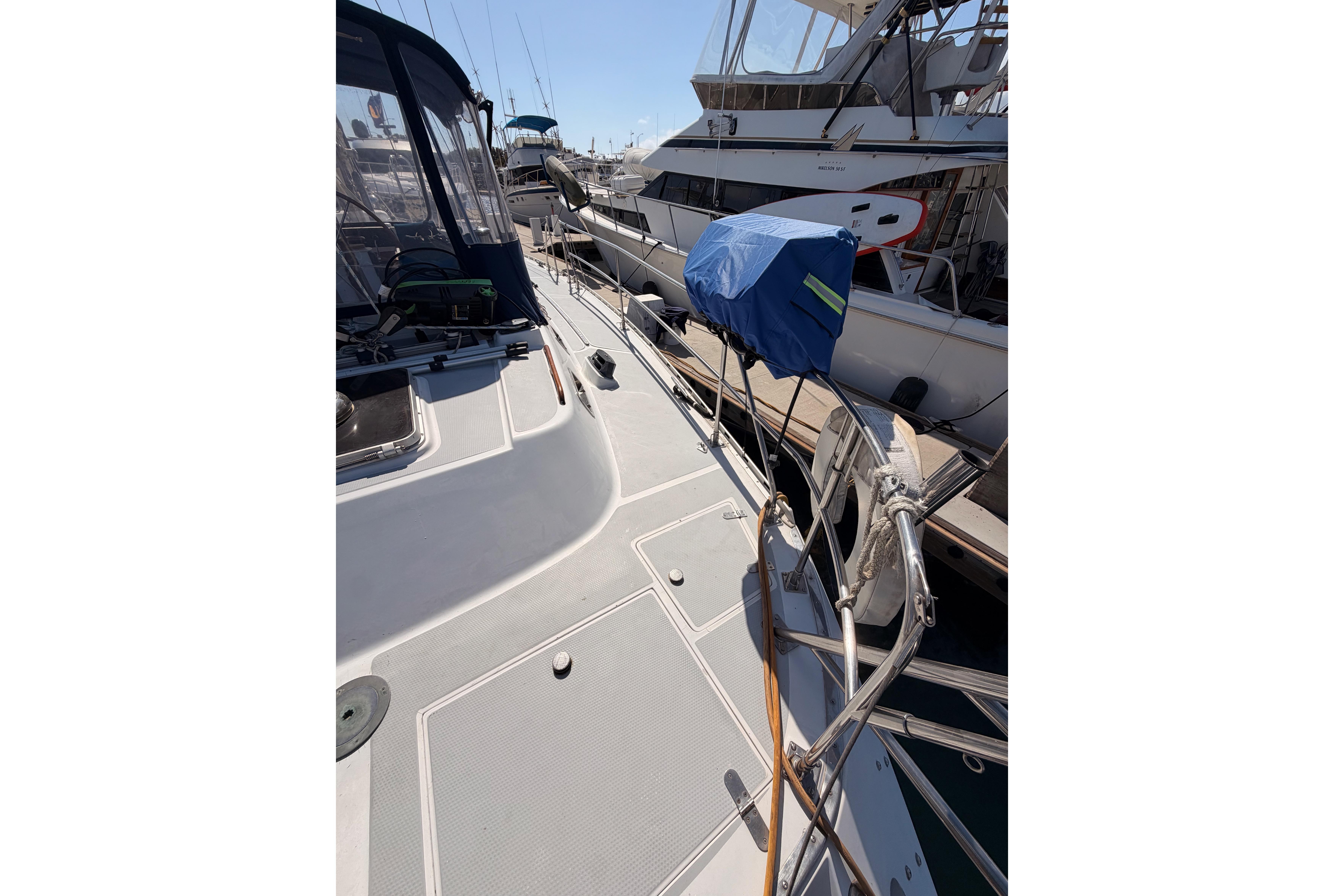 Sailboat deck view of a 1991 Hylas 51, docked at a marina.