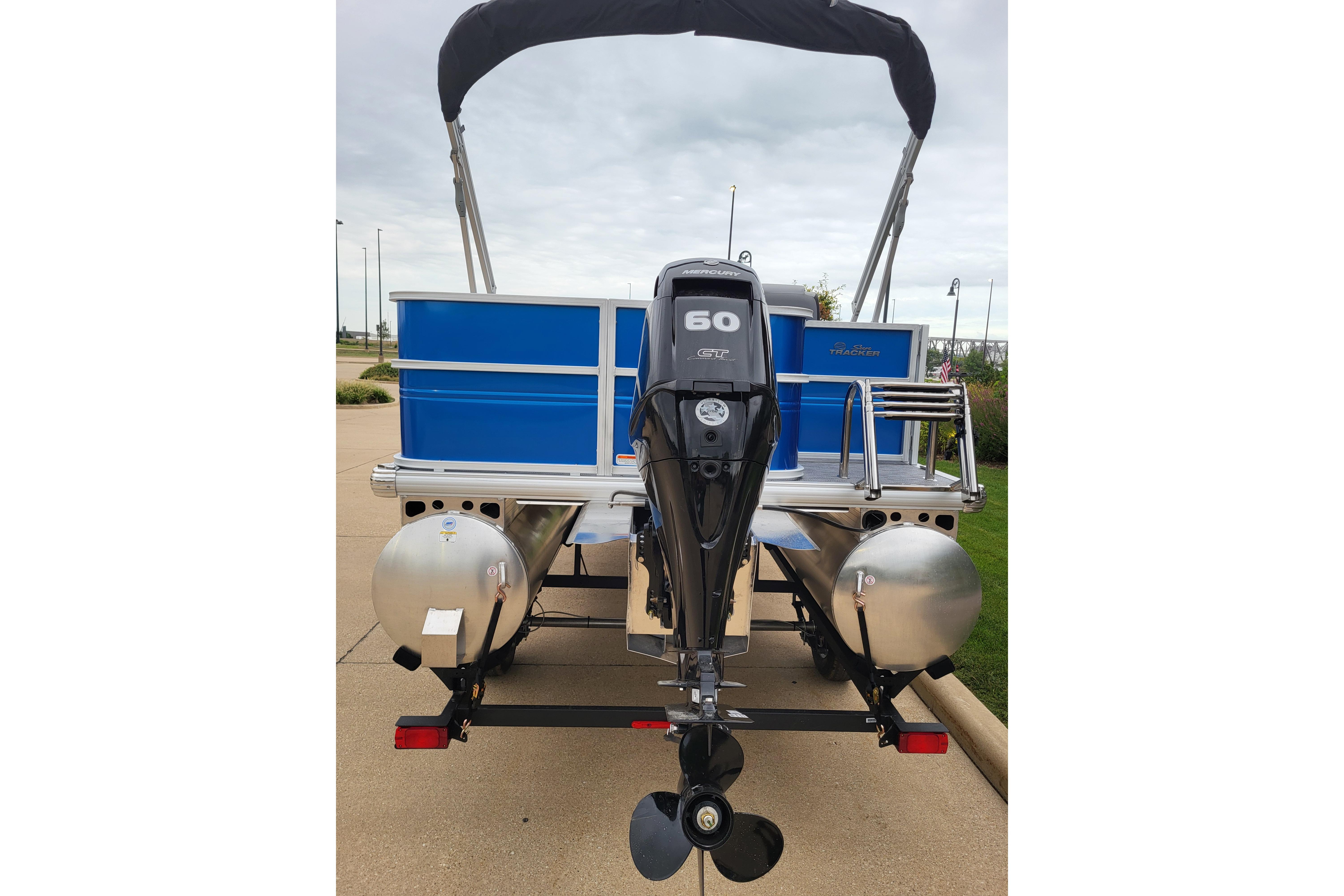 2026 Sun Tracker Party Barge 18 DLX pontoon boat with 60 HP engine, rear view.