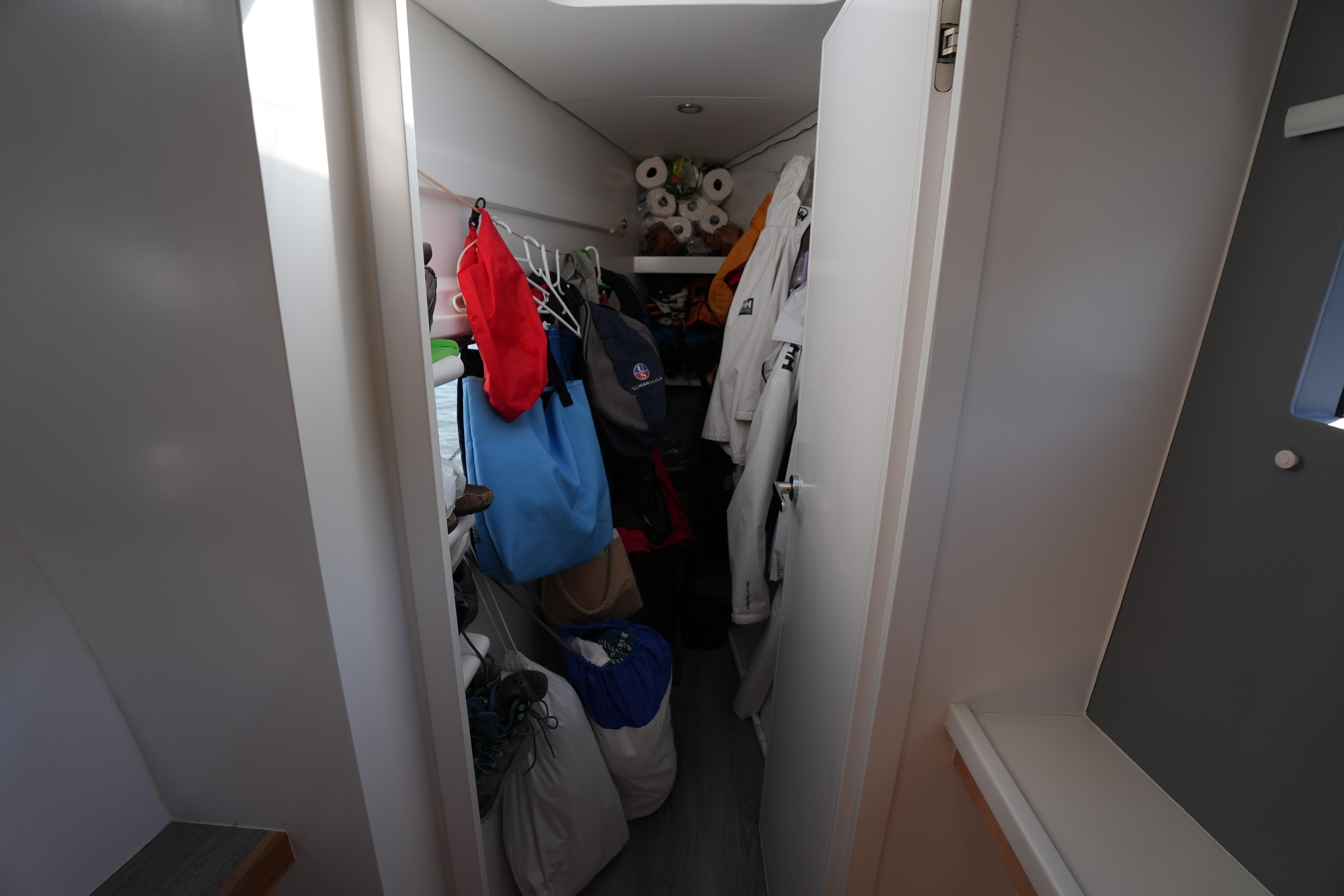 Narrow storage space on Balance 442 yacht, filled with clothes and supplies, 2024 model.