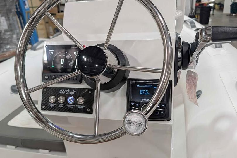 Steering console of 2027 Tide Craft San Juan 11 boat with modern controls and displays.