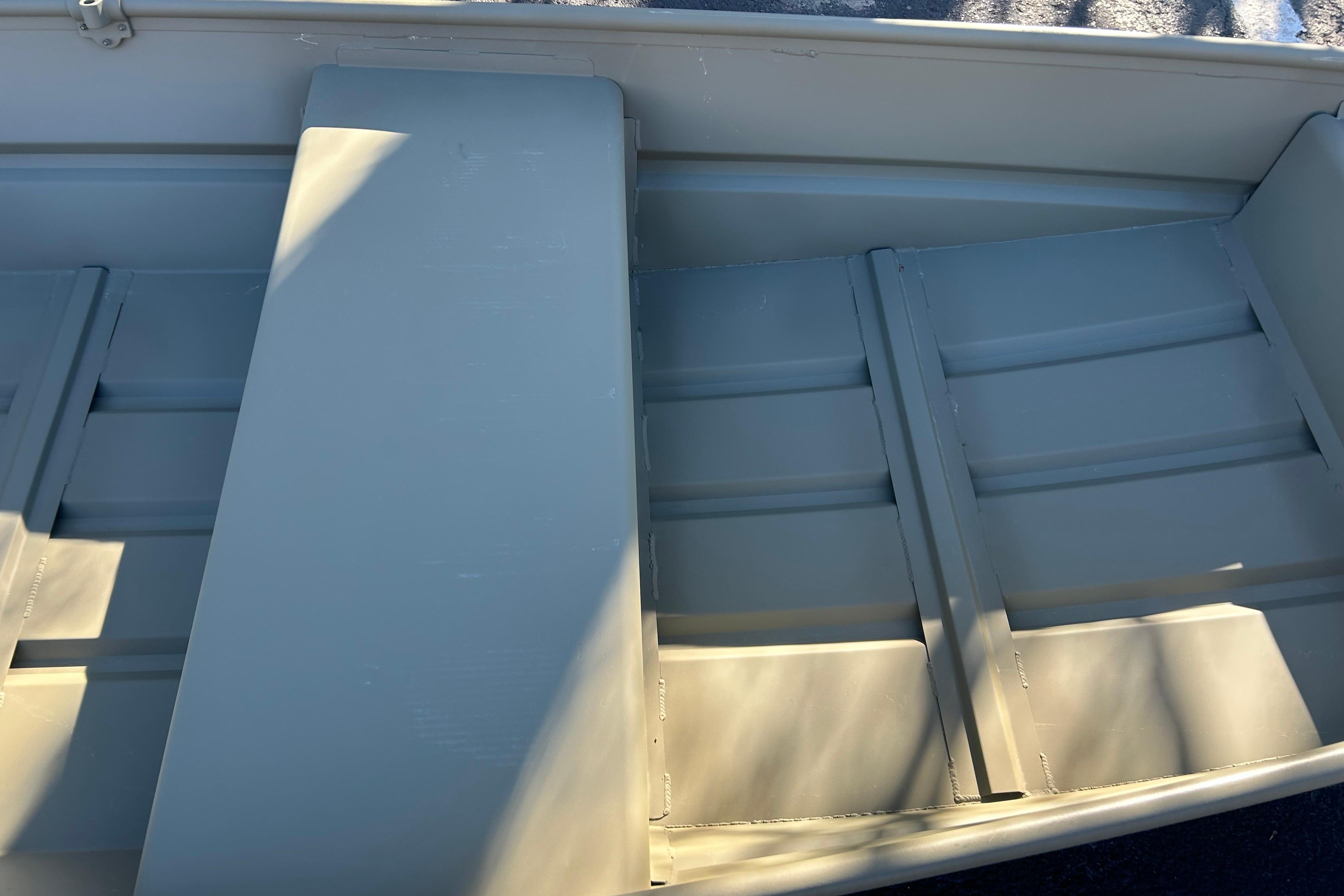 2026 Tracker Grizzly 12 Jon boat interior with bench seats and aluminum finish.