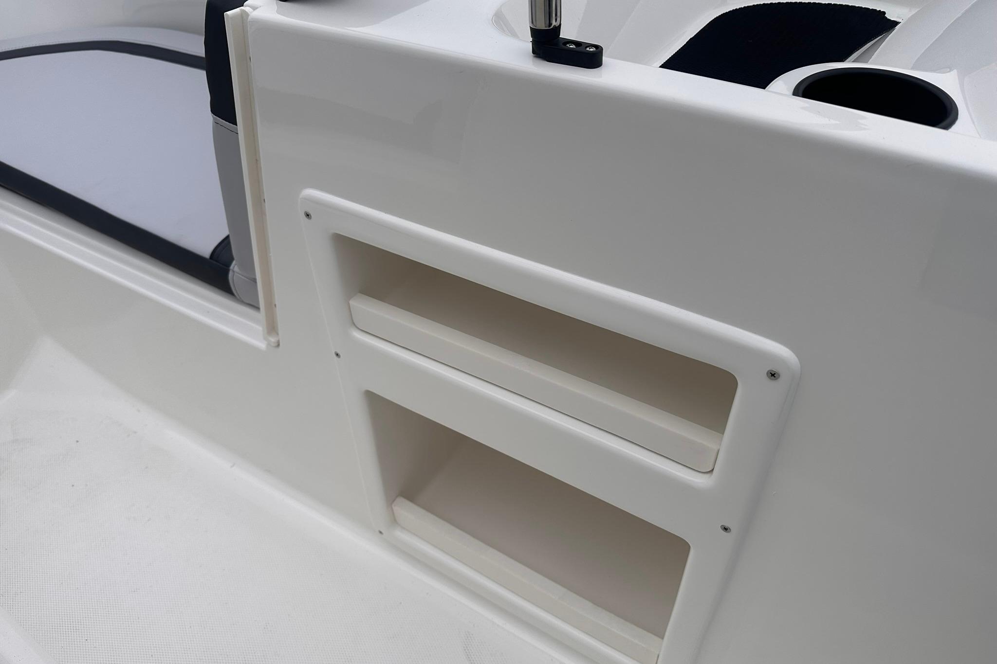 2026 Bayliner M17 boat interior with storage compartments and seating area.
