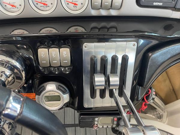 Control panel of a 2005 Cobalt 343 boat with gauges and switches.