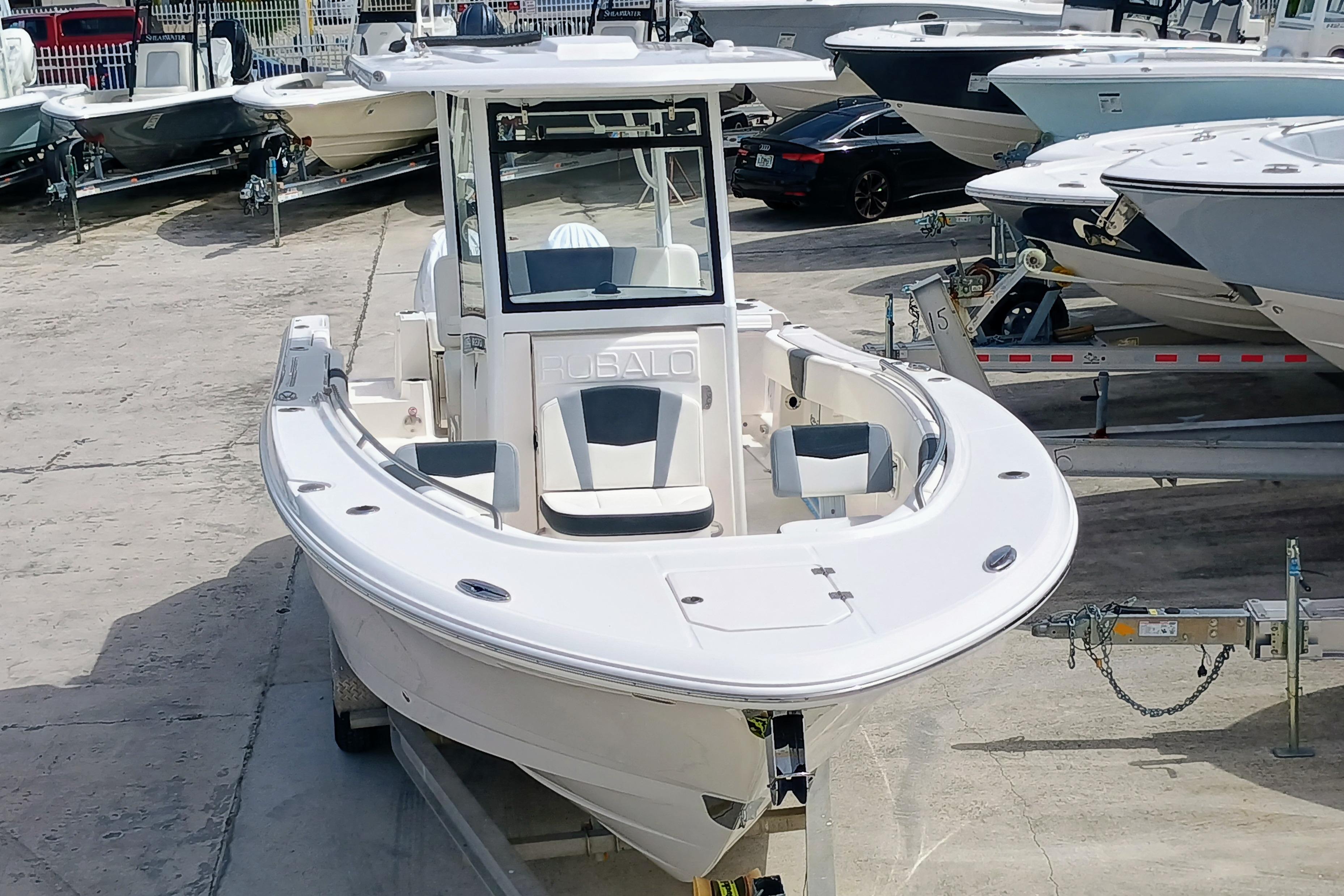 2025 Robalo R270 Center Console boat on display at a marina.