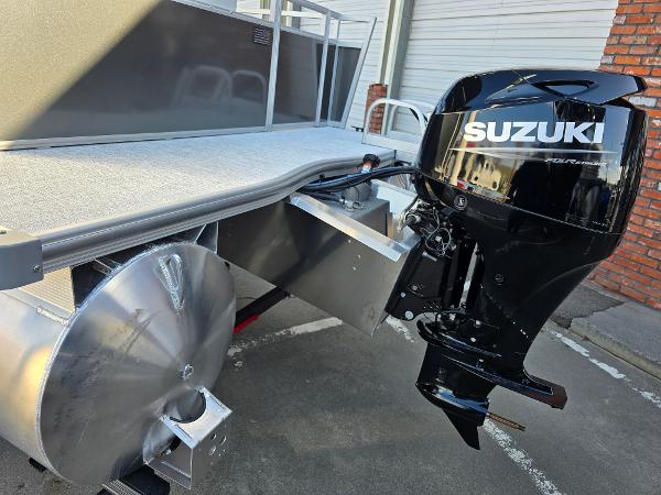 2025 Berkshire 20 CL pontoon boat with Suzuki outboard motor, parked outdoors.