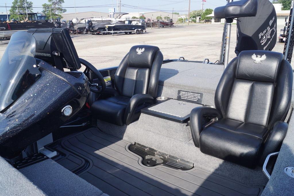 Interior of 2025 Phoenix 921 Elite boat with black leather seats and modern dashboard.