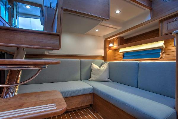 Interior of the 2027 Sabre 38 Salon Express with blue upholstery and wood accents.