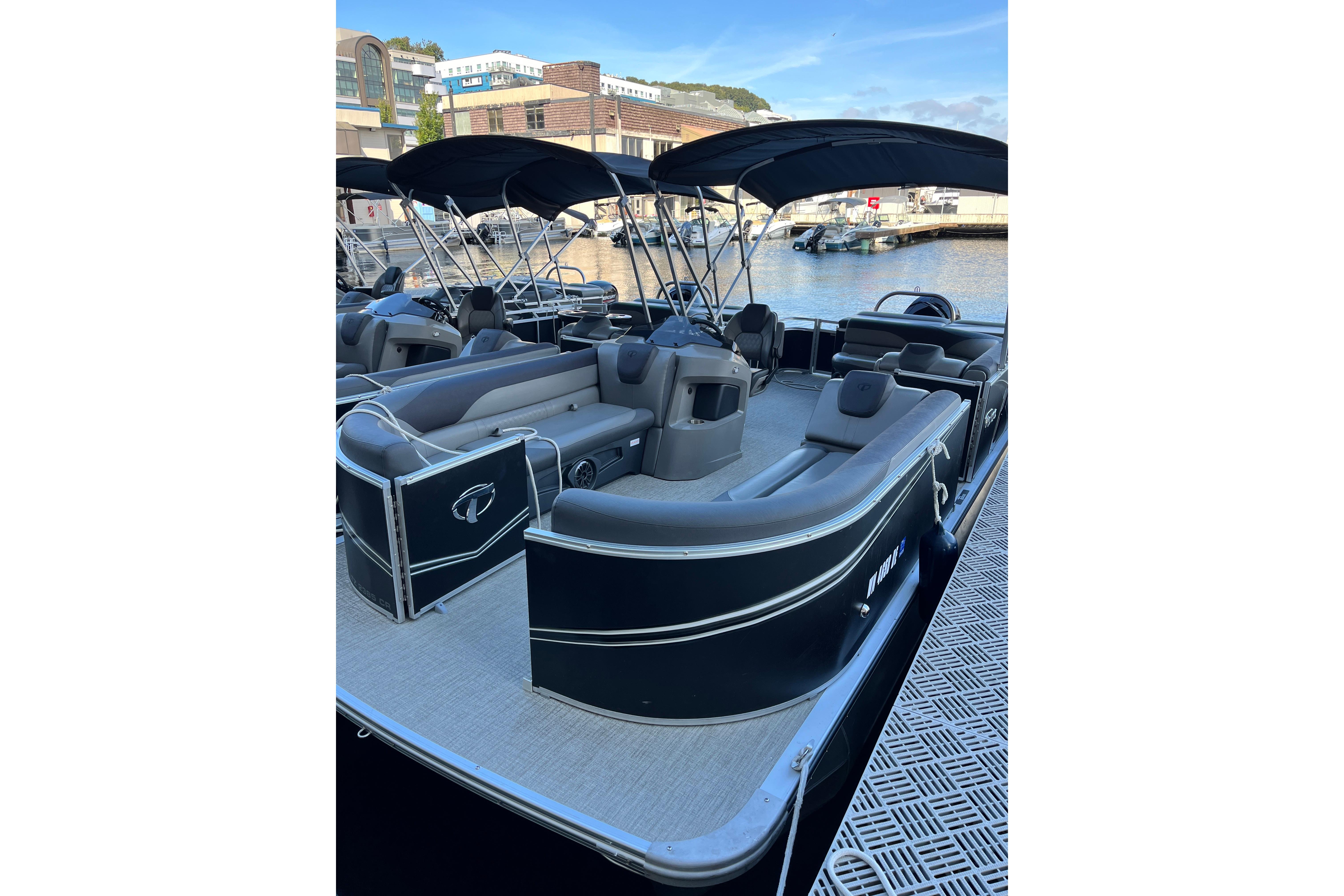 2023 Tahoe Pontoon LTZ Cruise boat docked, featuring spacious seating and sleek design.