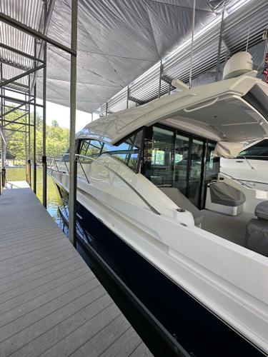 2019 Tiara Yachts C53 docked under a covered marina.