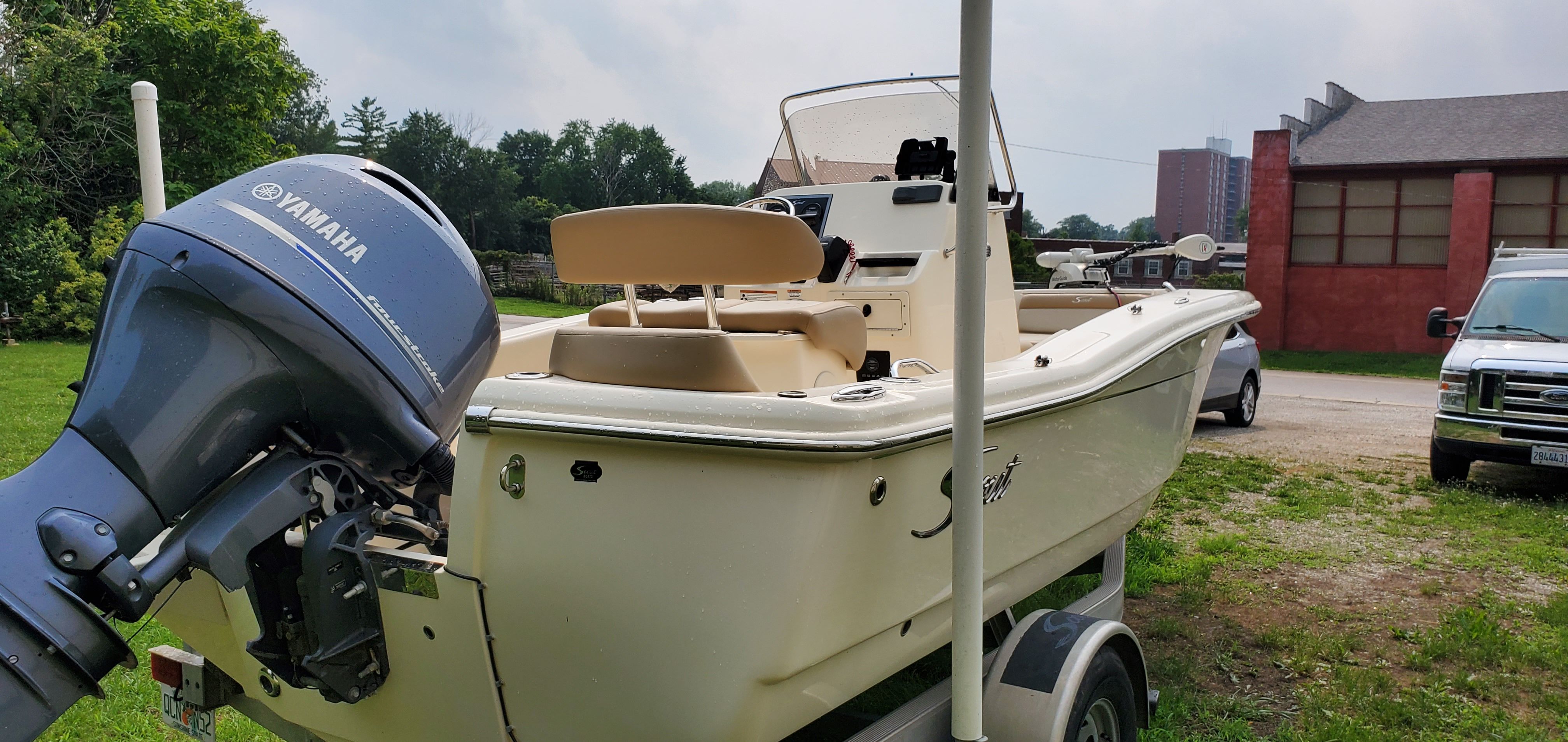 A 2021 Scout 195 Sportfish boat on a trailer outdoors.