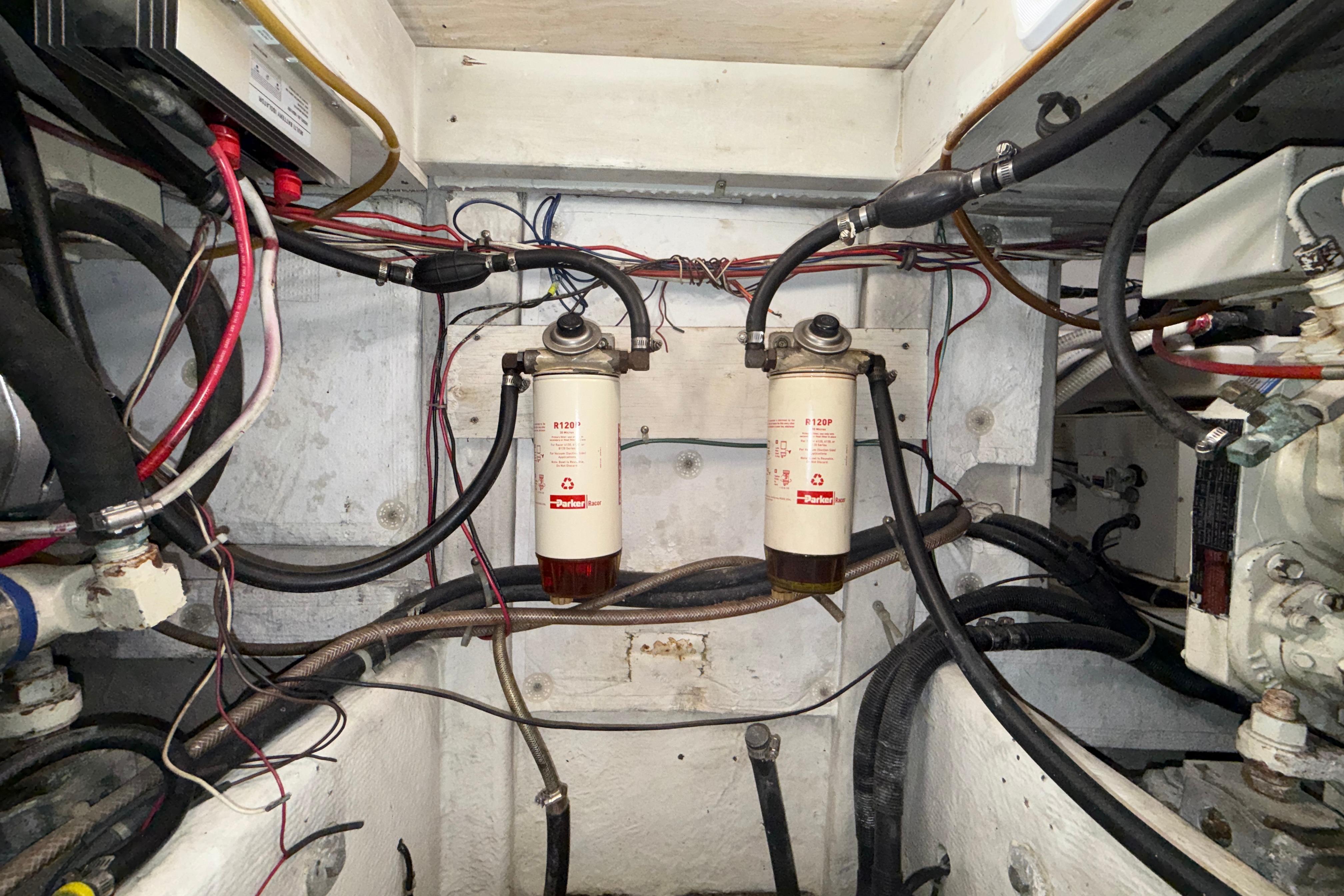 Engine room of 1997 Bayliner 3988 Command Bridge Motoryacht with fuel filters and wiring.