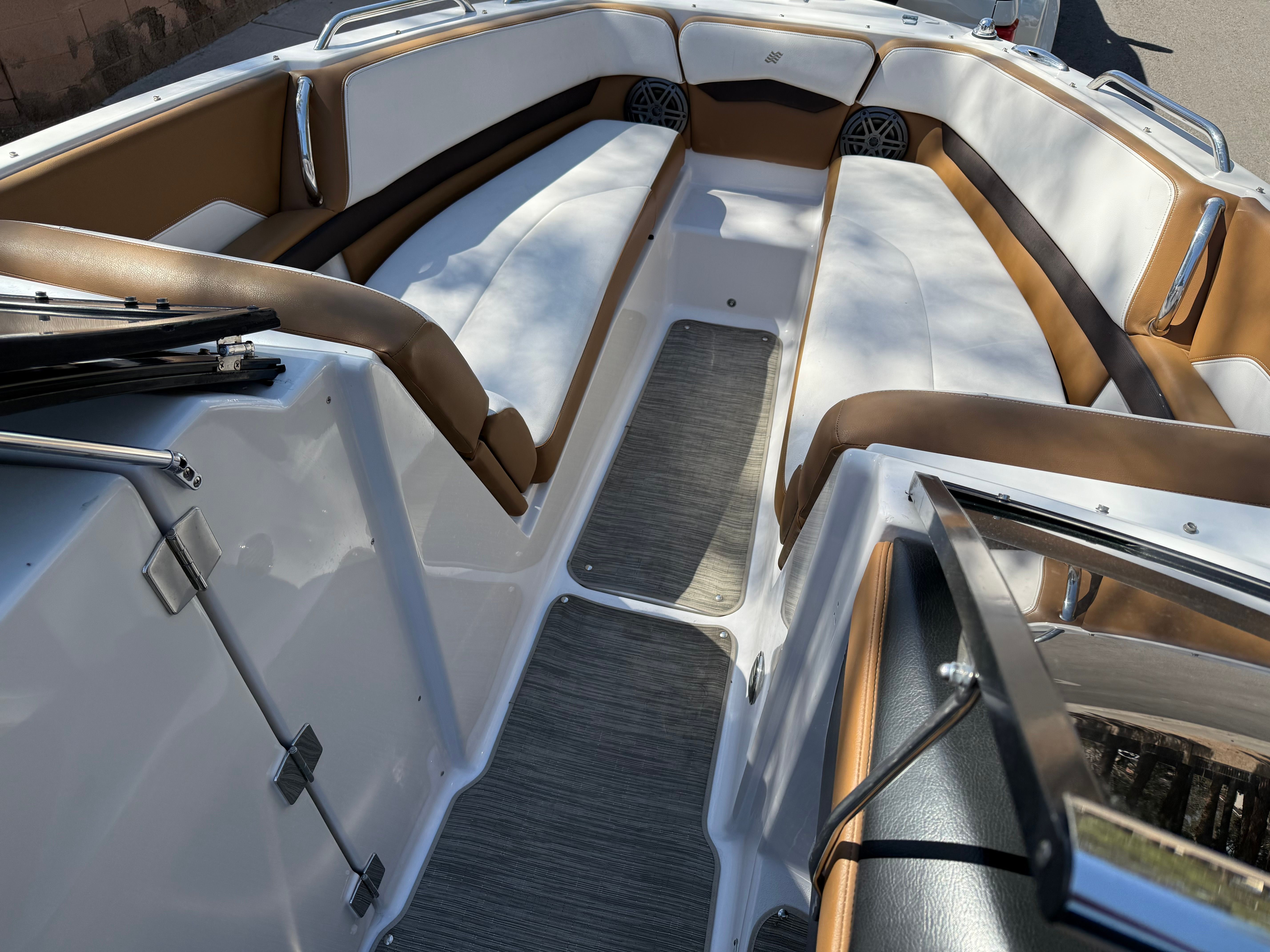 Interior of 2019 Four Winns H260 boat with brown and white seating.