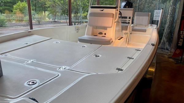 2023 Mako Pro Skiff 19 CC boat interior with seating and storage compartments.