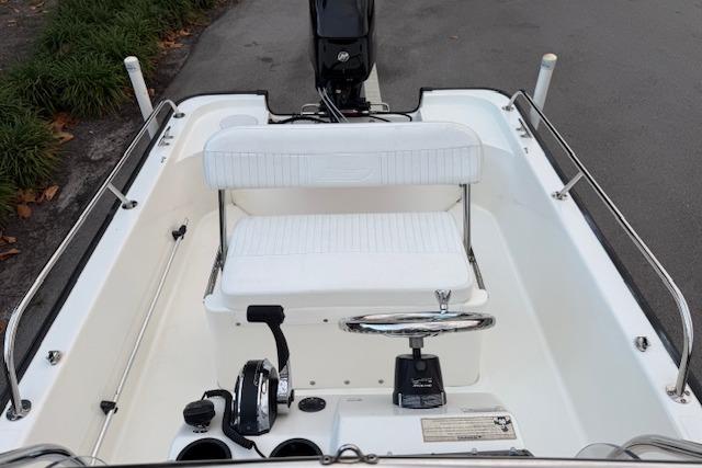 2016 Boston Whaler 150 Montauk boat interior with steering wheel and seating.