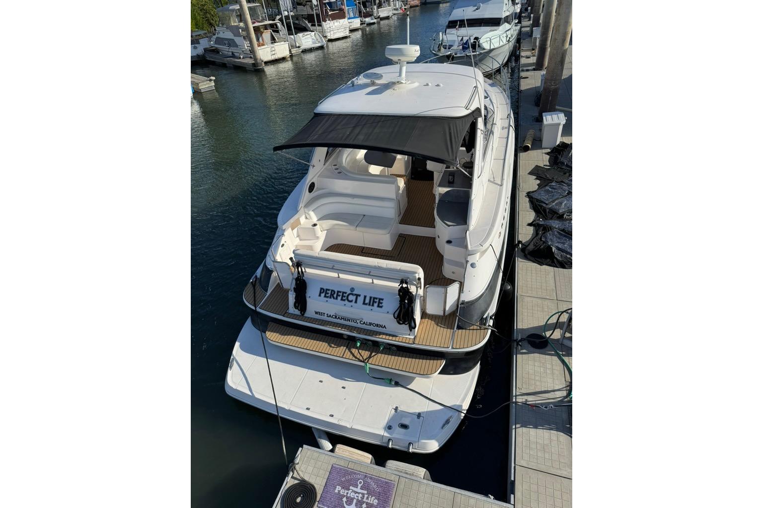 2006 Regal Commodore 4460 yacht docked at marina, rear view.