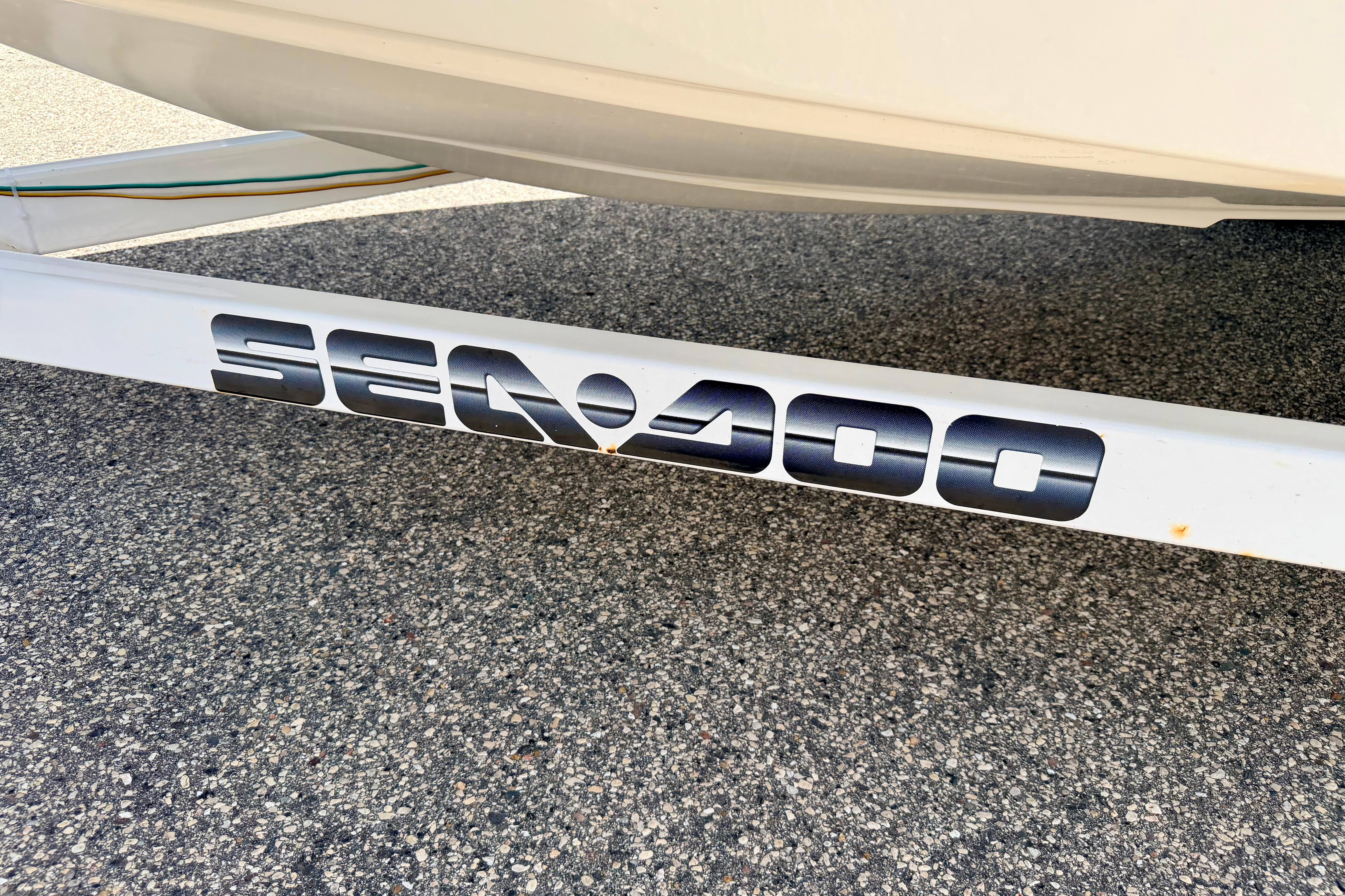 2004 Bombardier SEADOO Utopia 185 trailer with logo on pavement background.