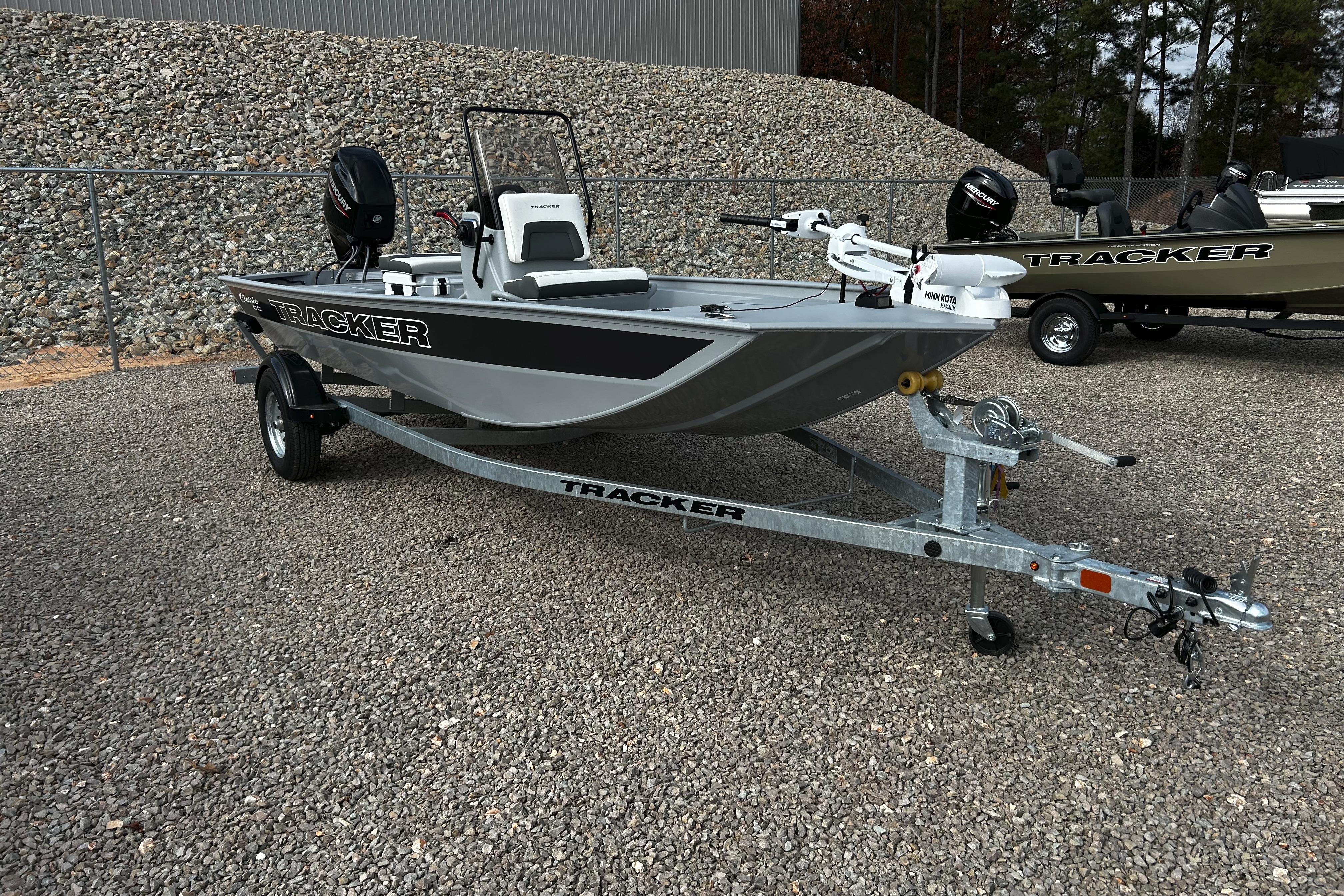 2026 Tracker Bass Tracker Classic CC boat on trailer, parked on gravel.