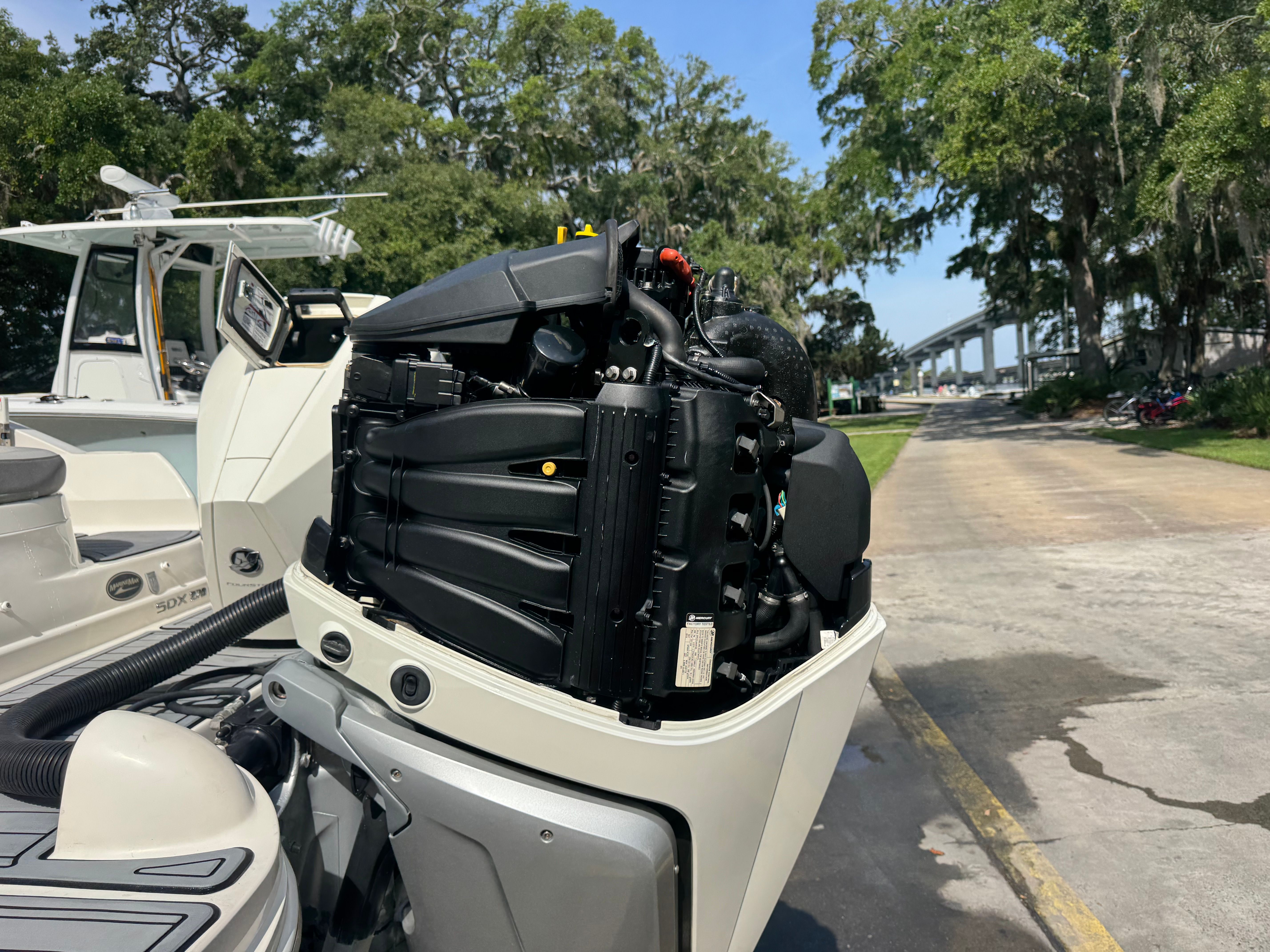 2020 Sea Ray SDX 270 outboard motor at a sunny dock.