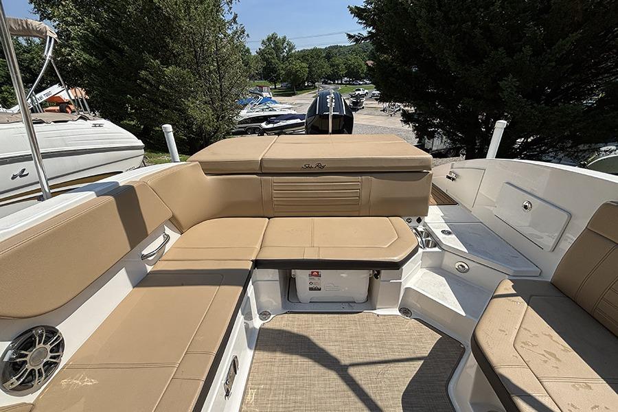 2019 Sea Ray SPX 230 Outboard boat interior with tan seating and storage compartments.