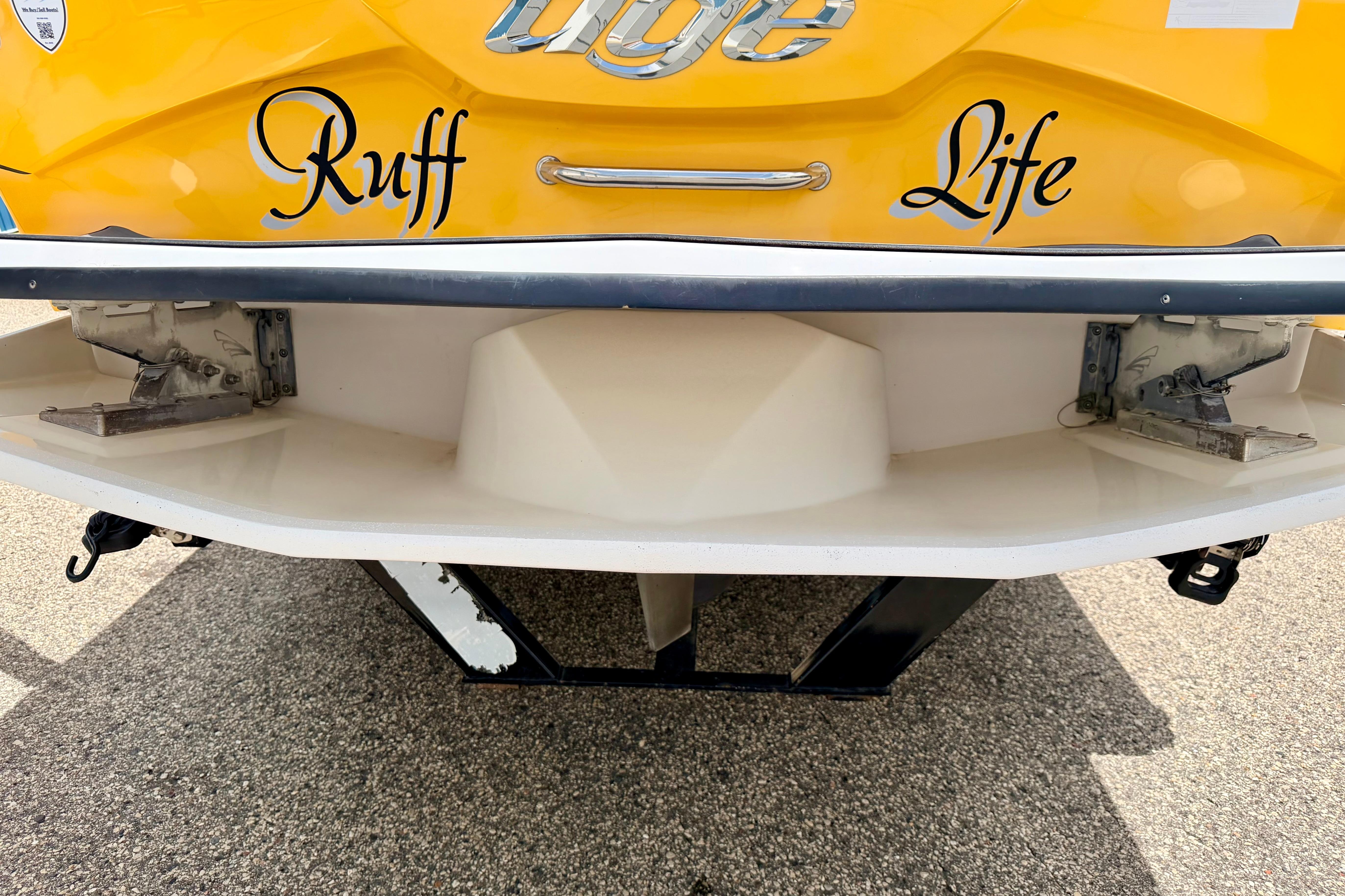 Yellow 2014 Tigé R20 boat with "Ruff Life" text on the stern.