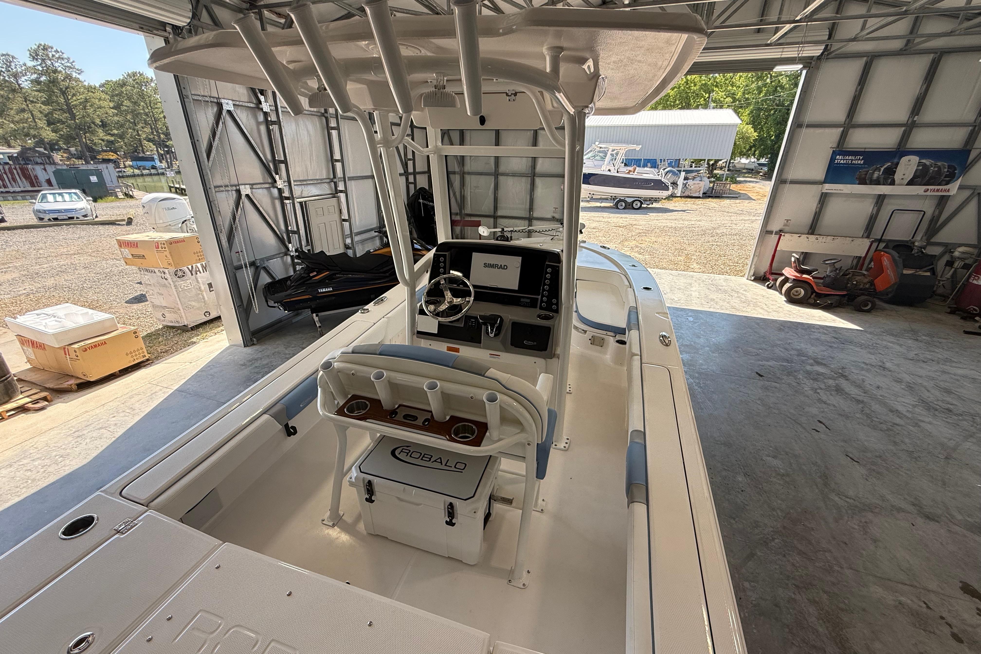 2026 Robalo 246 Cayman boat interior in a garage setting.