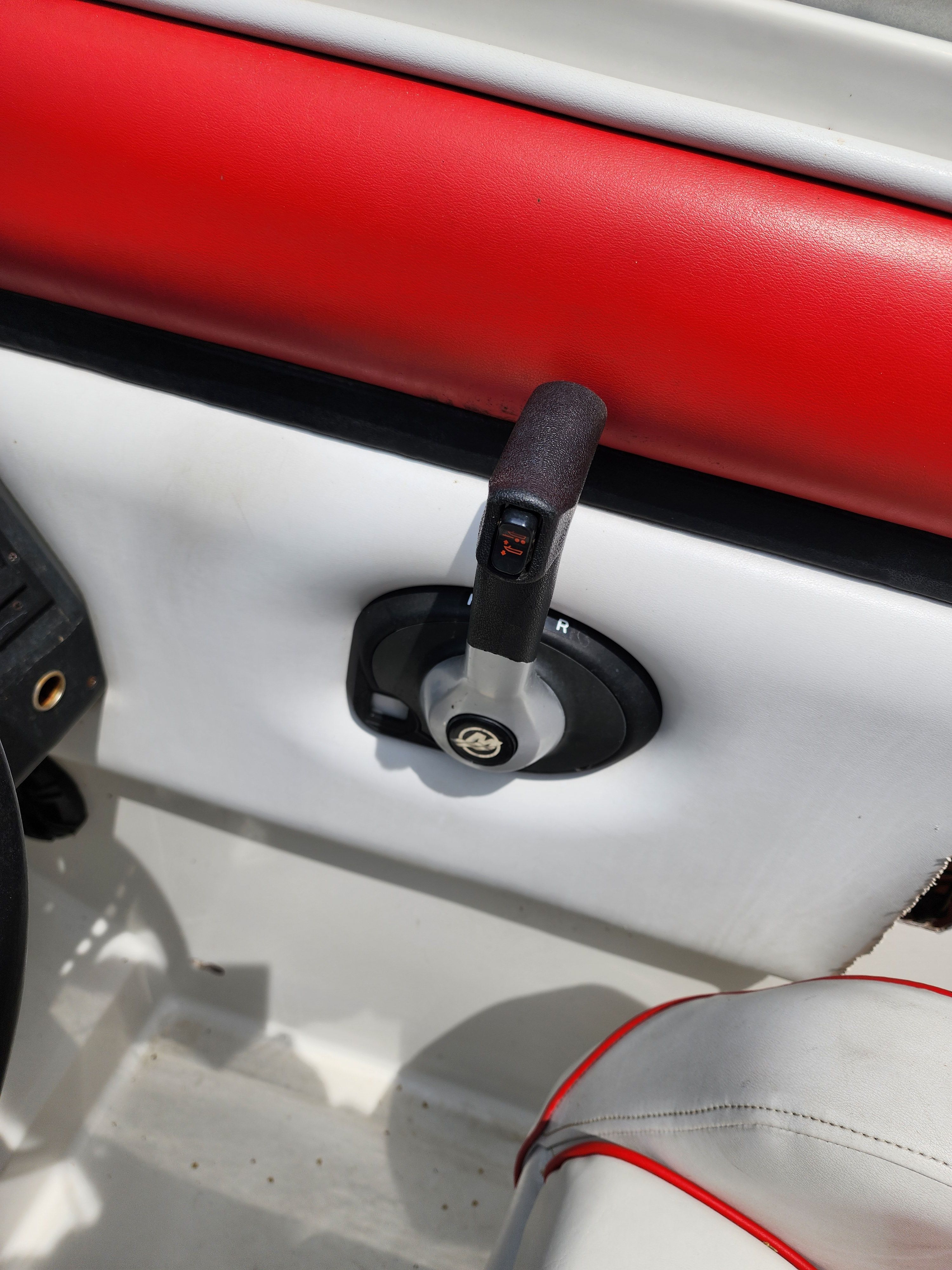 Regal Valante 225C 1990 boat control with red upholstery.
