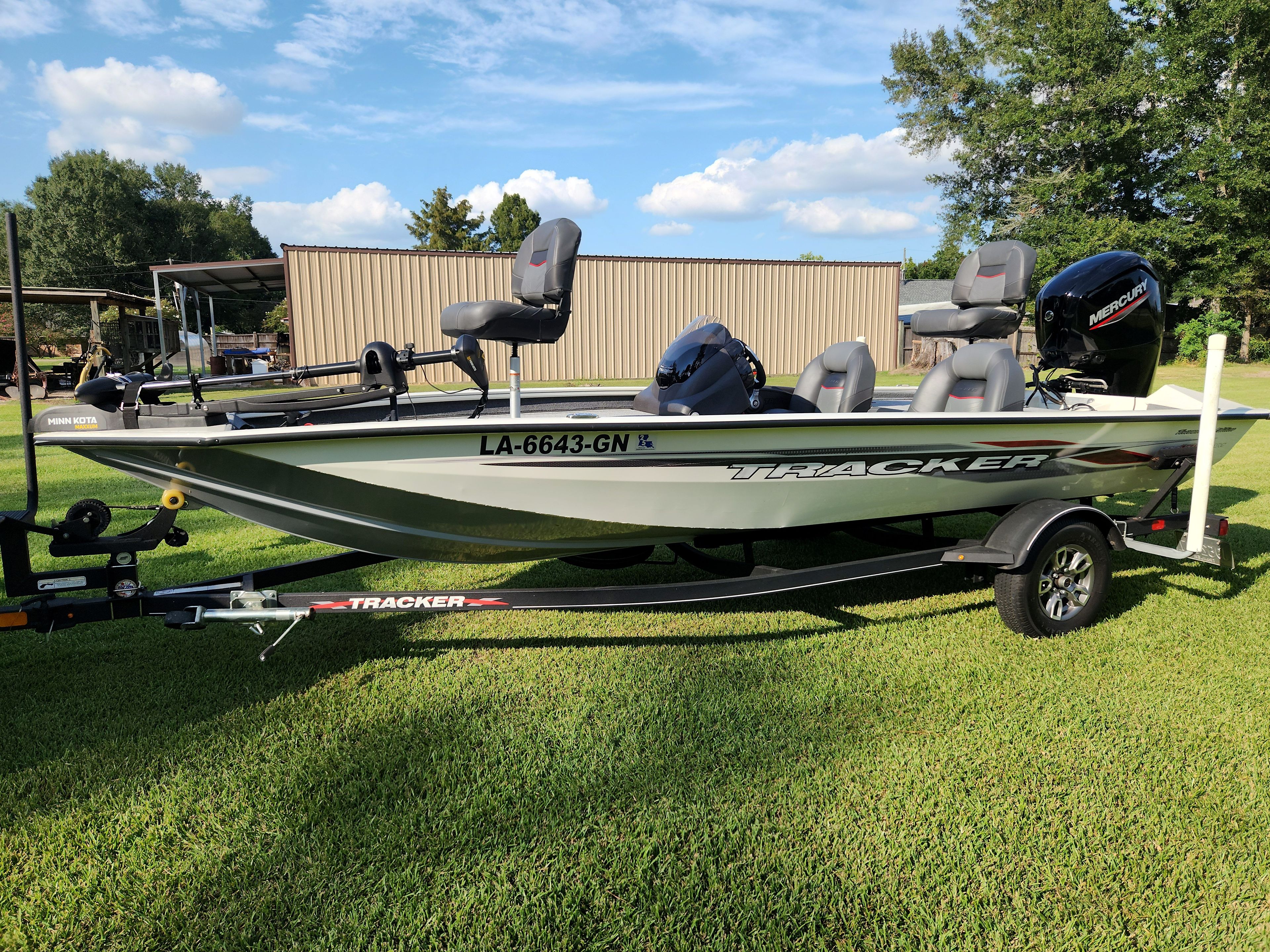 A 2022 Bass Tracker Pro 175 TE on a trailer on a grassy lawn.