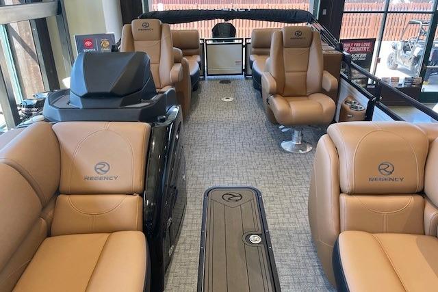 Luxurious interior of 2026 Regency 230 DL boat with tan leather seating and modern design.