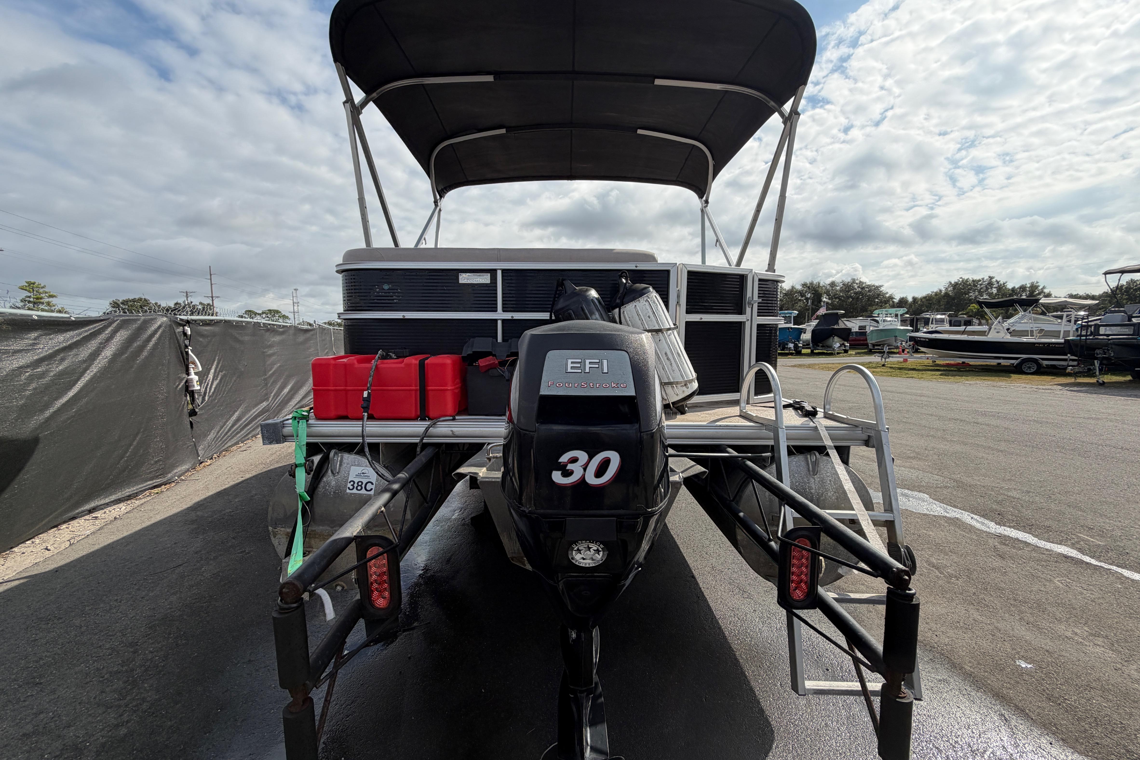2014 Starcraft Stardeck 190 Cruise pontoon boat with EFI 30 engine, parked outdoors.
