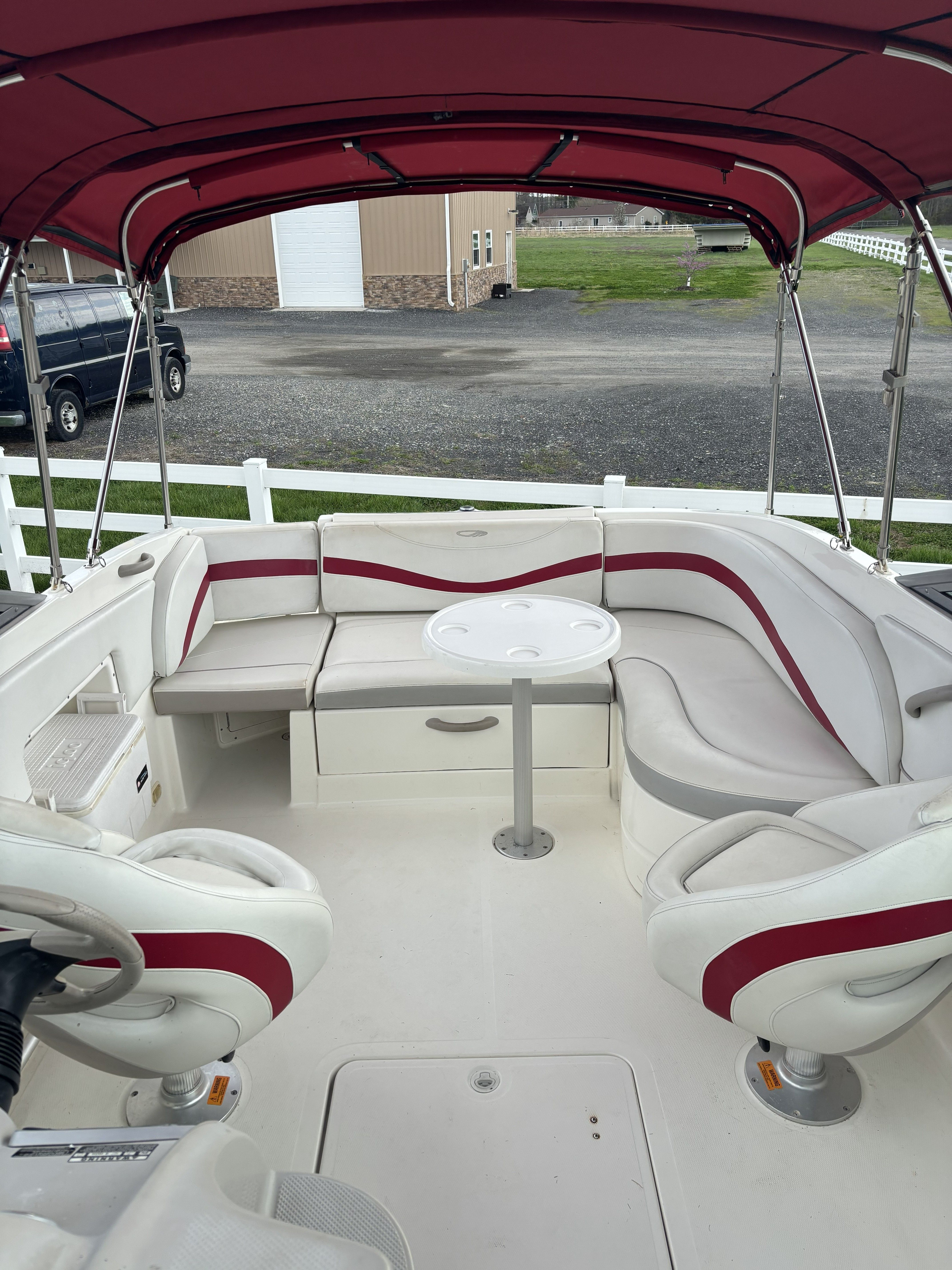 Interior of a 2005 Maxum 2400 SC3 boat with red canopy.