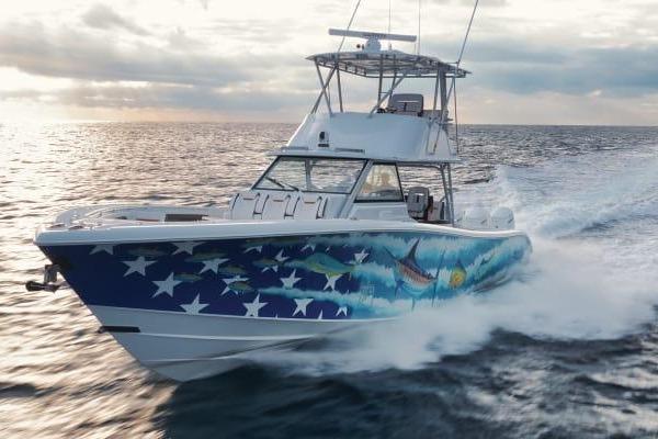 2022 Yellowfin 54 Offshore boat with vibrant marine-themed hull design cruising on open water.