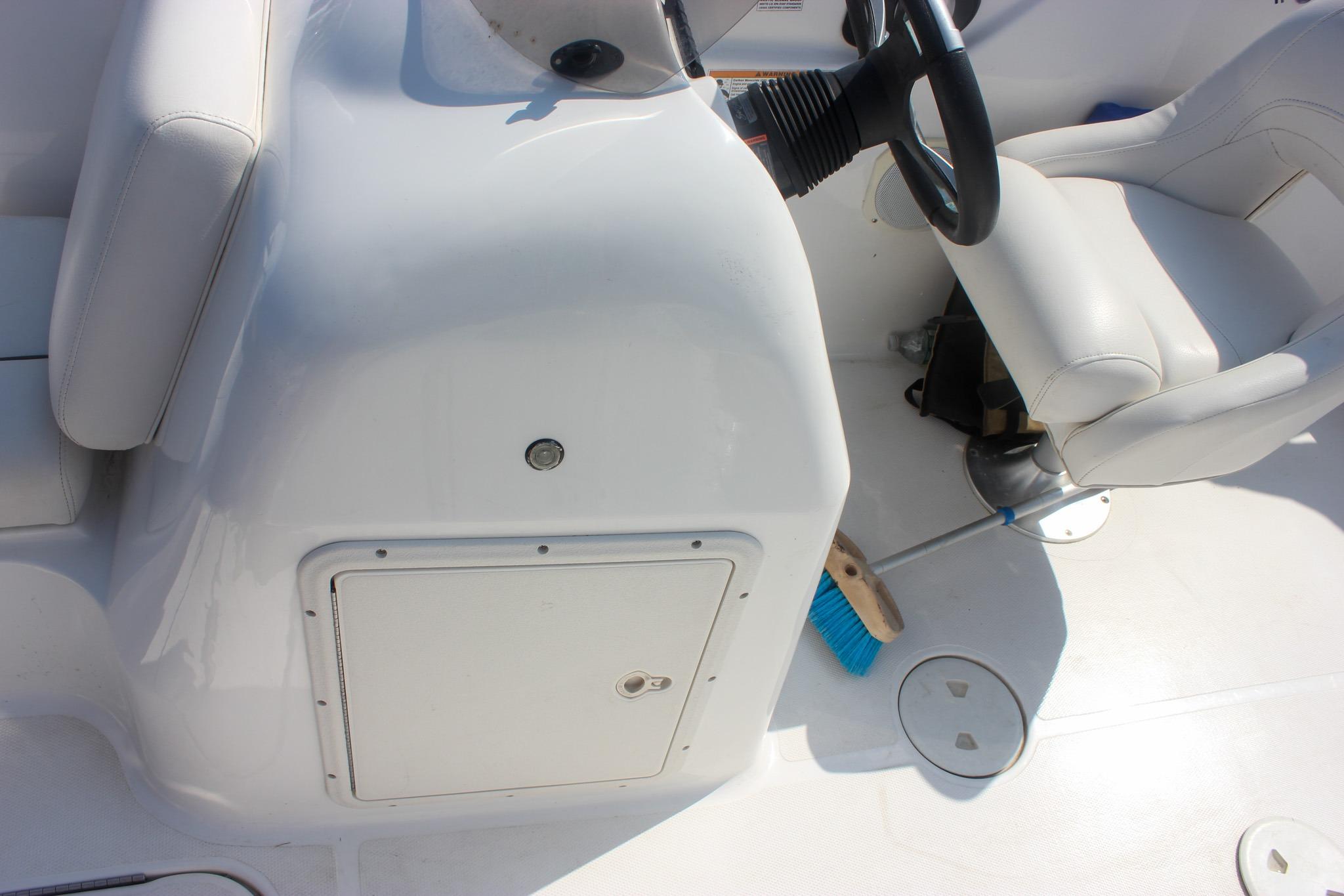 2013 Hurricane SunDeck Sport 188 OB boat interior with steering wheel and seating.