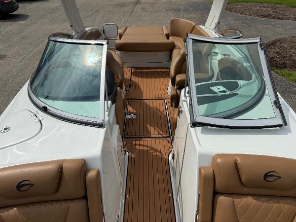 2025 Crownline 290 SS boat with tan leather seats and open windshield.