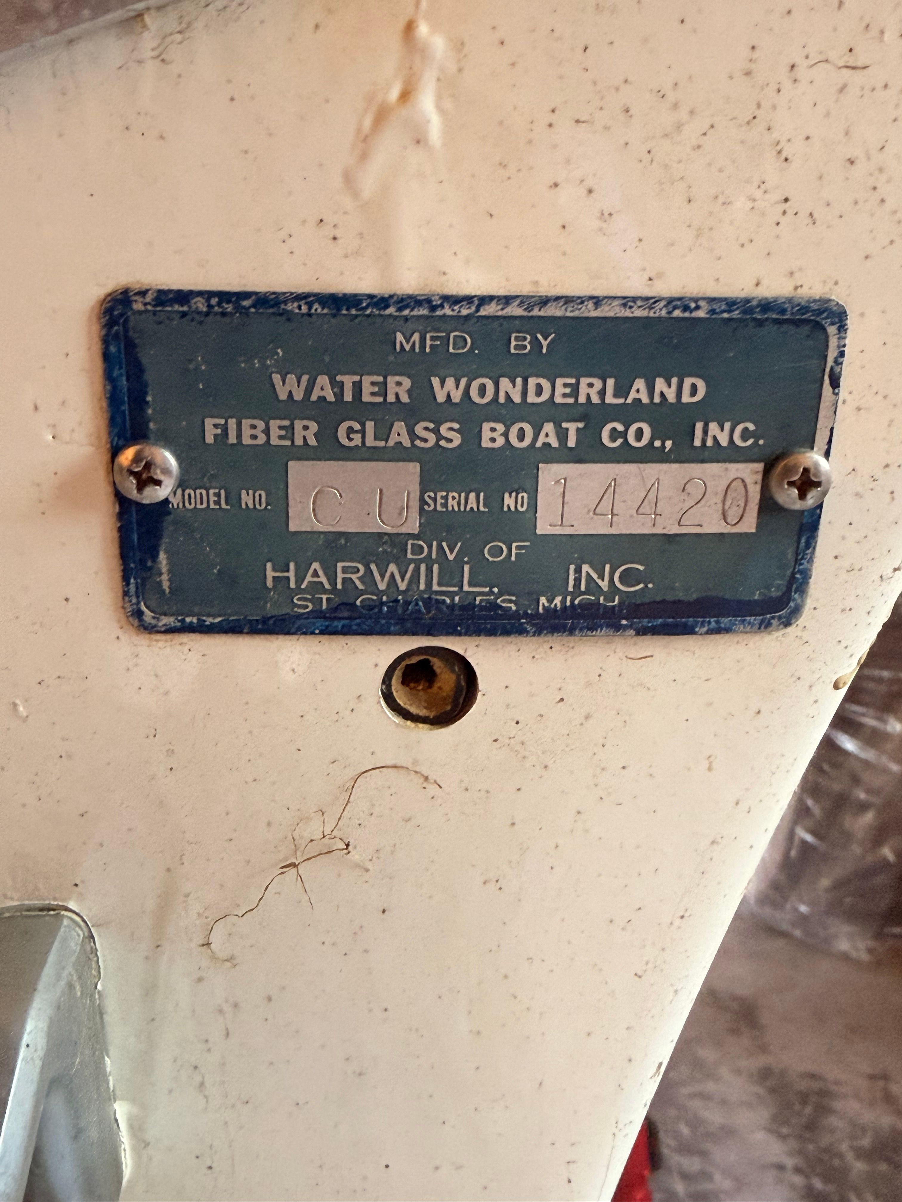 A blue metal plate with manufacturer information for a boat.