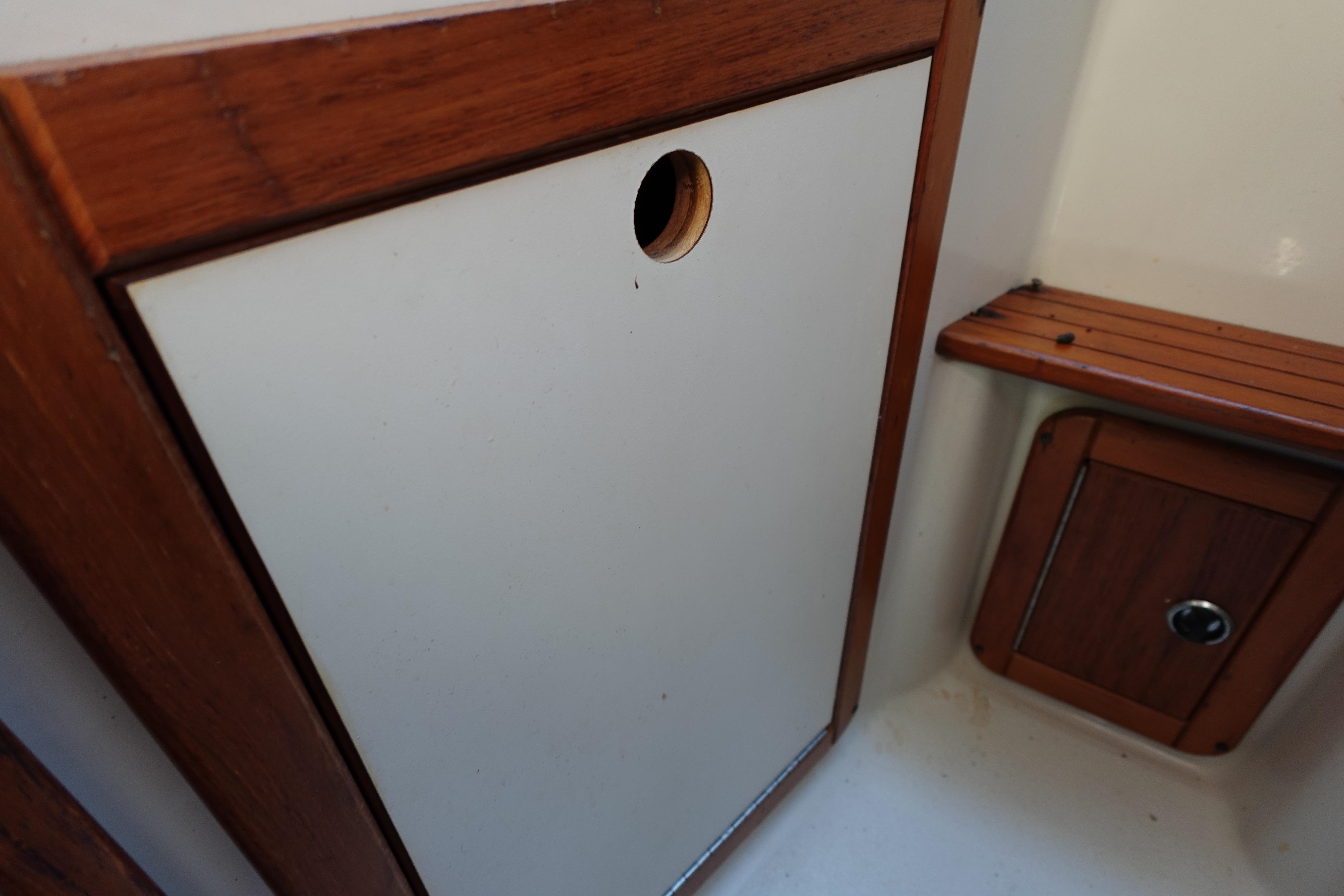 Interior of a 1997 Catalina 28 sailboat, featuring wooden cabinetry and seating.