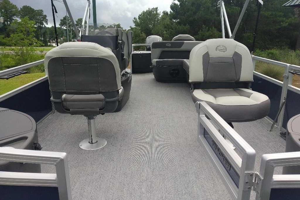 2026 Sun Tracker Bass Buggy 18 DLX pontoon boat interior with gray seating and carpet.