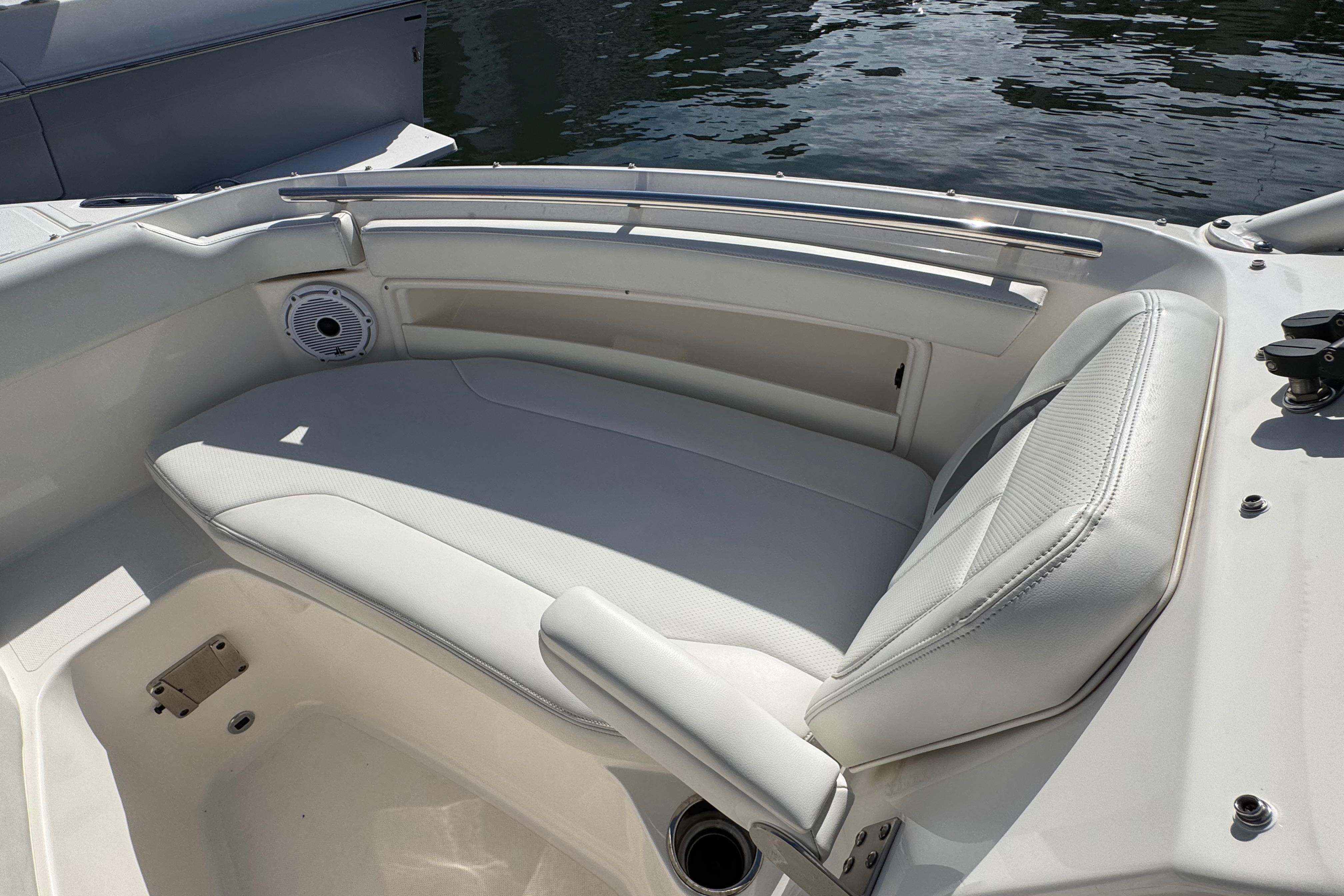2022 Pursuit DC 266 Dual Console boat with white seating and speaker, docked by water.