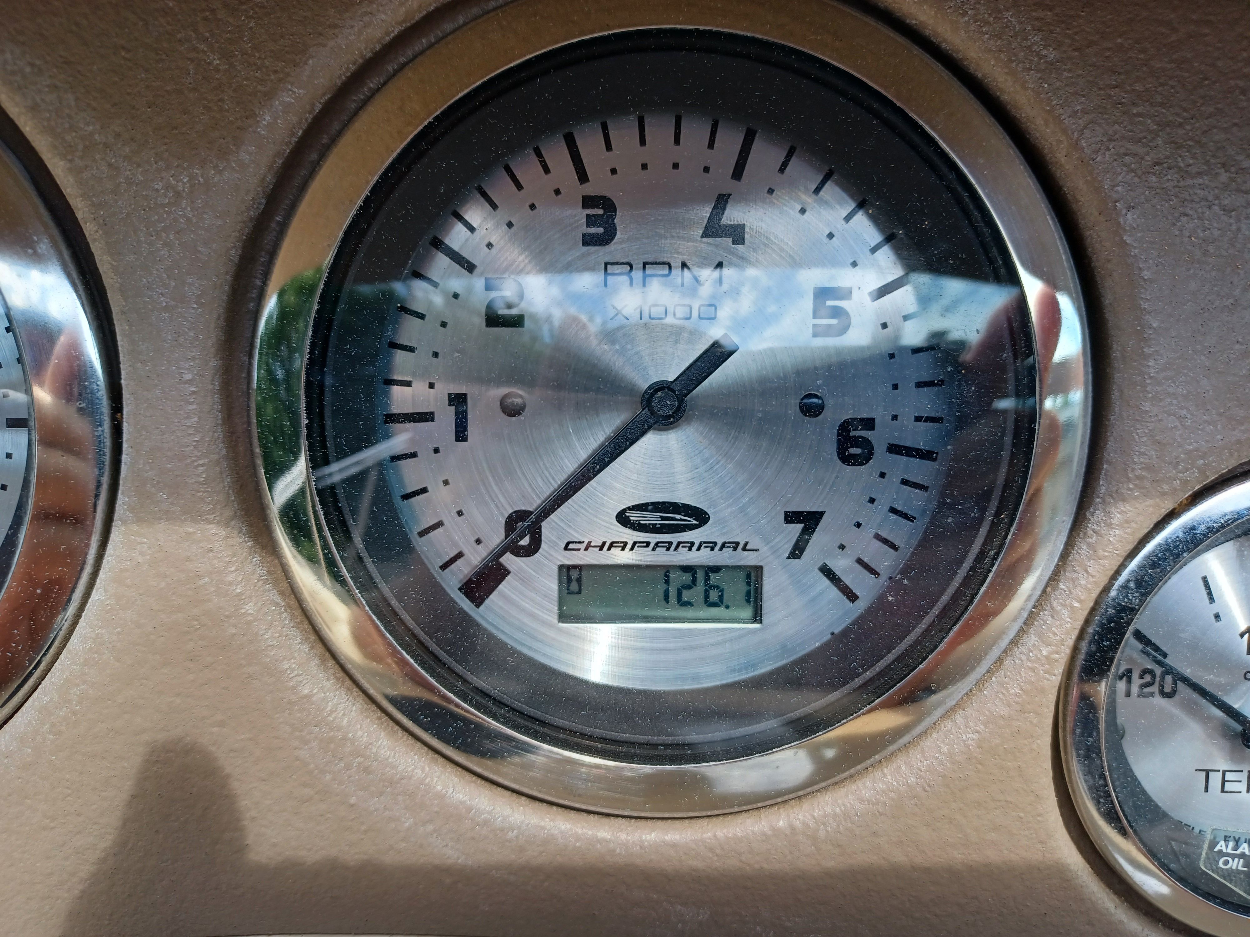 Close-up of a tachometer in a Chaparral 215 SSi boat, showing 1261 RPM.