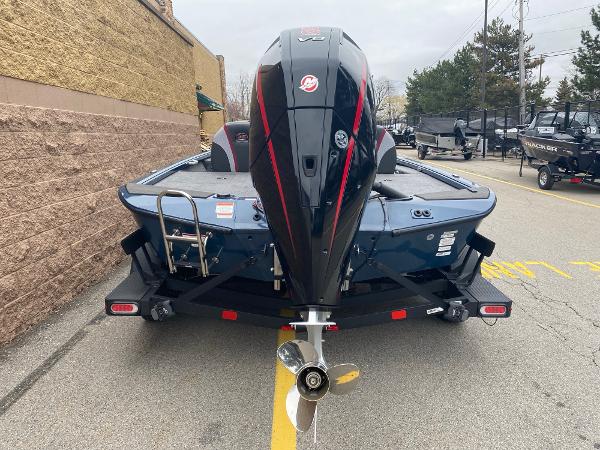 2025 Ranger ALPHA 208 boat, rear view with powerful outboard motor, parked outdoors.