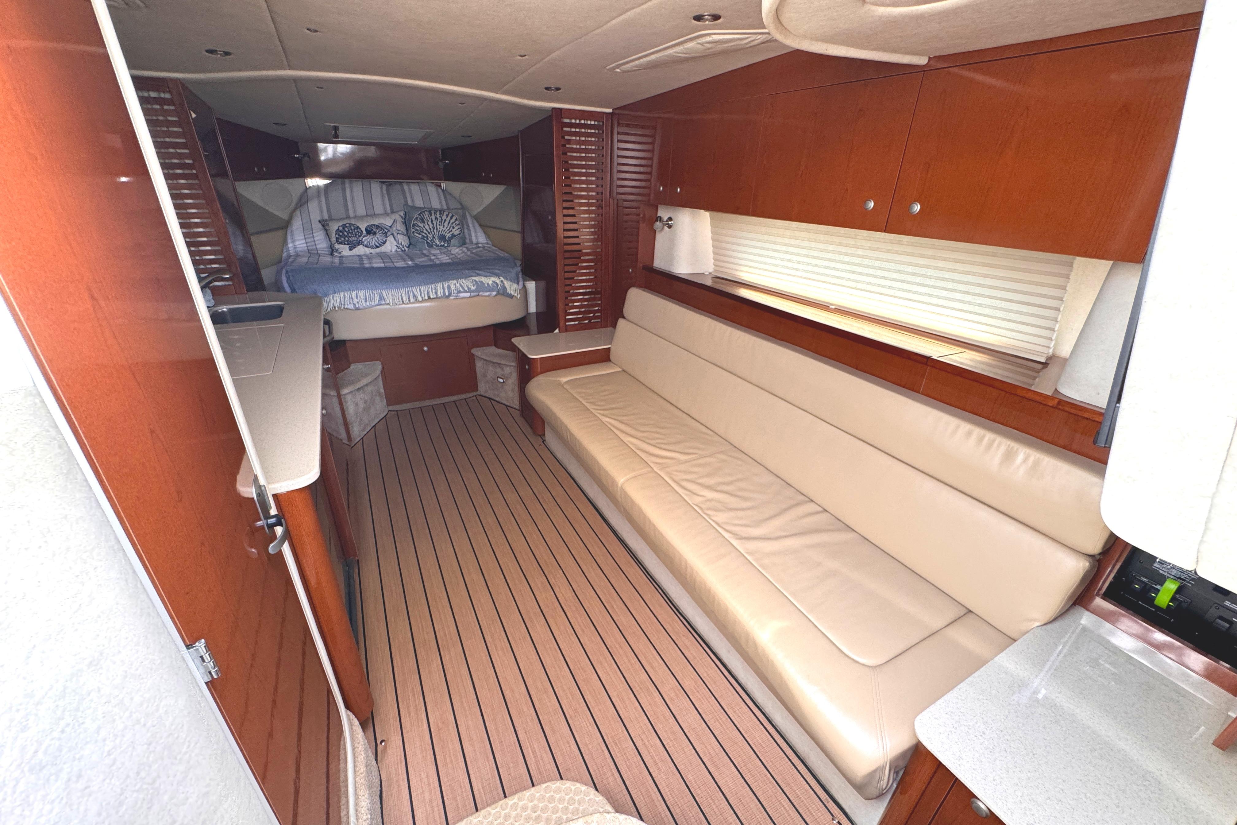 Interior of 2008 Sea Ray Sundancer 350 yacht with beige seating and wooden accents.