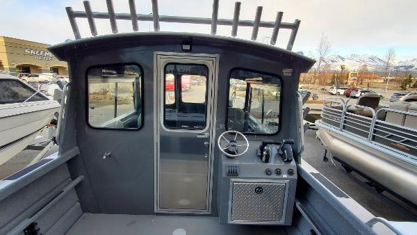 2023 Spartan 220 Maximus boat interior with steering wheel and control panel.