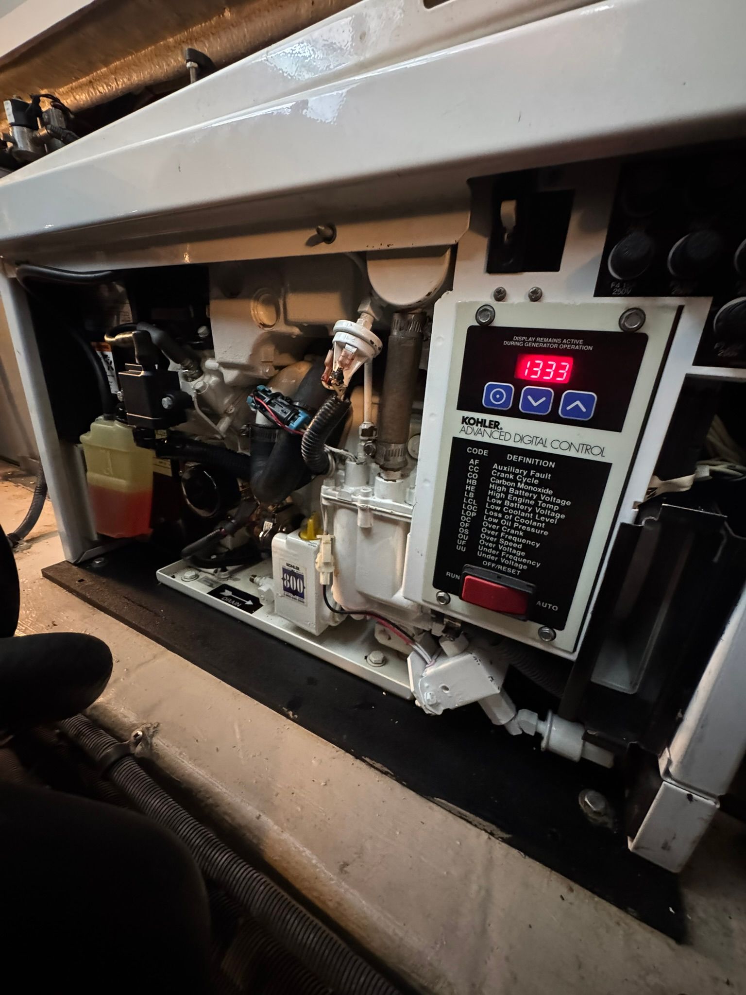 A generator compartment with a digital control panel and various mechanical components.