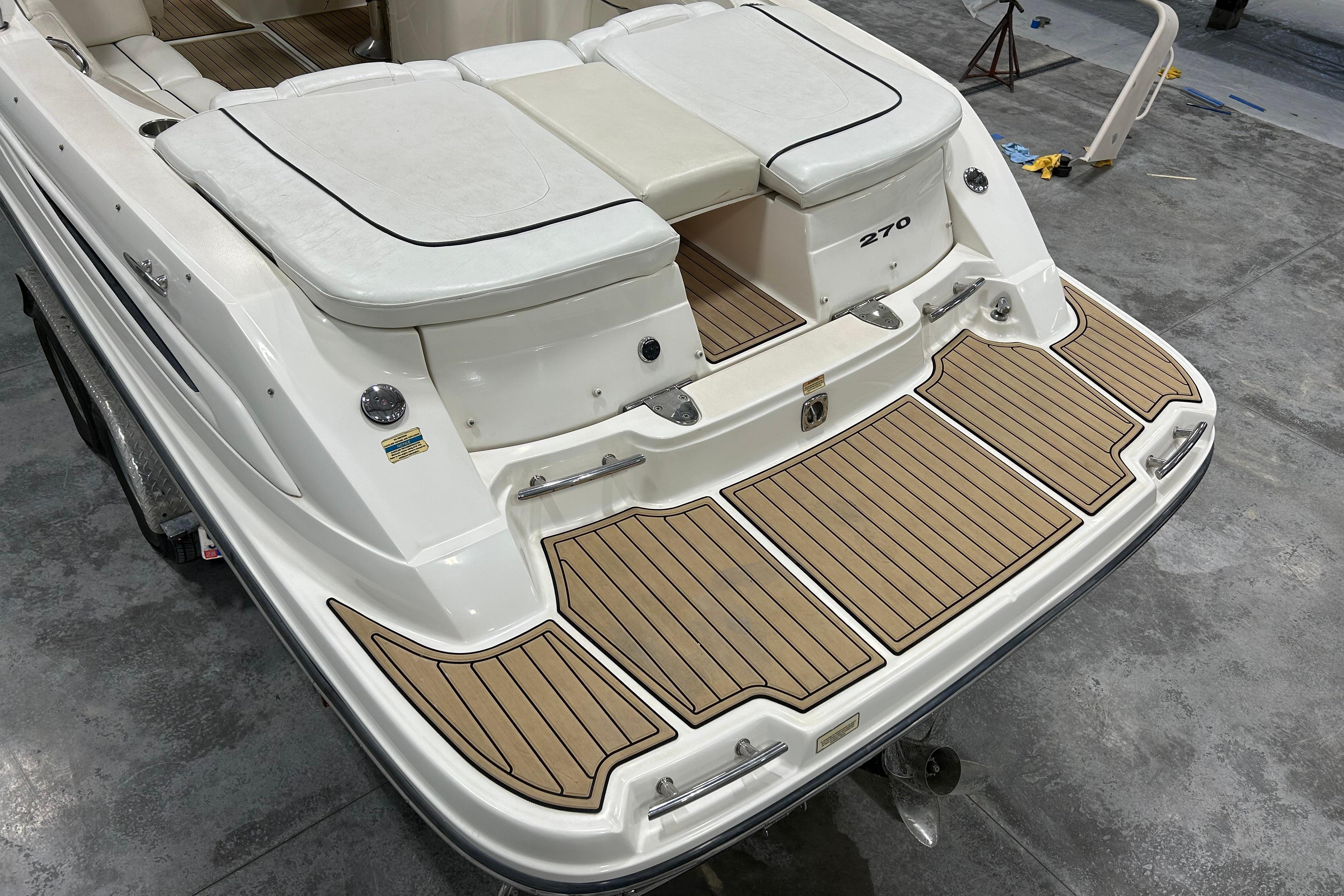 2006 Sea Ray 270 SLX boat with teak-style swim platform and cushioned seating.