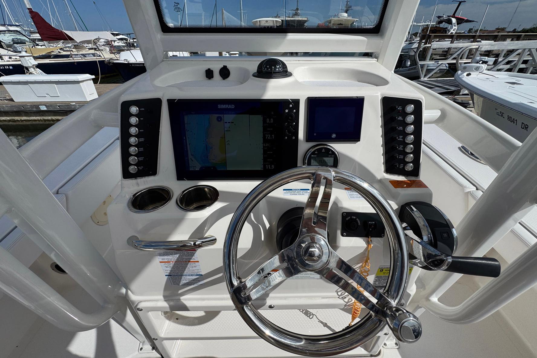 2021 Robalo 246 Cayman boat dashboard with steering wheel and navigation controls.